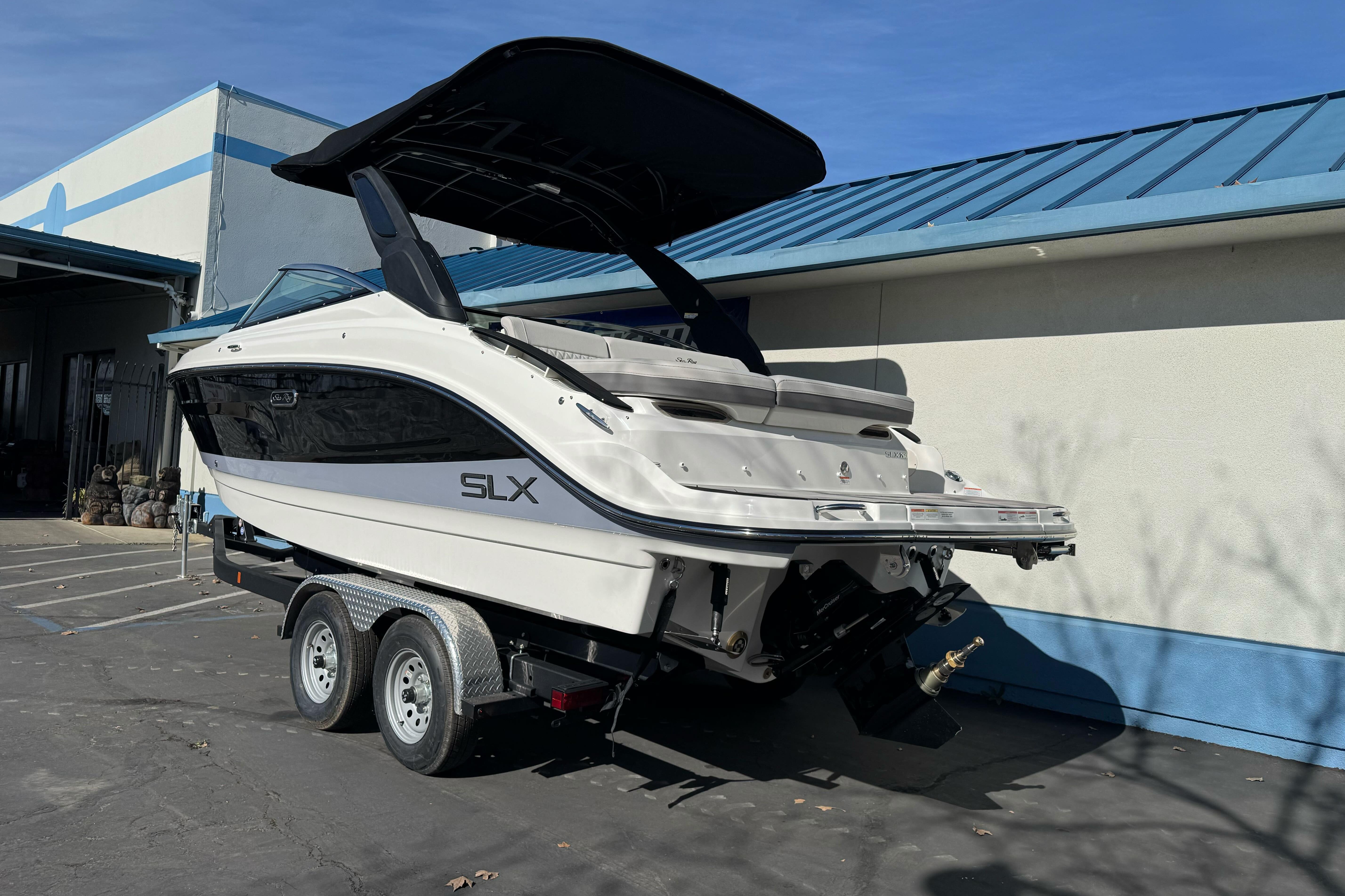 2026 Sea Ray SLX 260 boat on trailer, parked outdoors near a building.