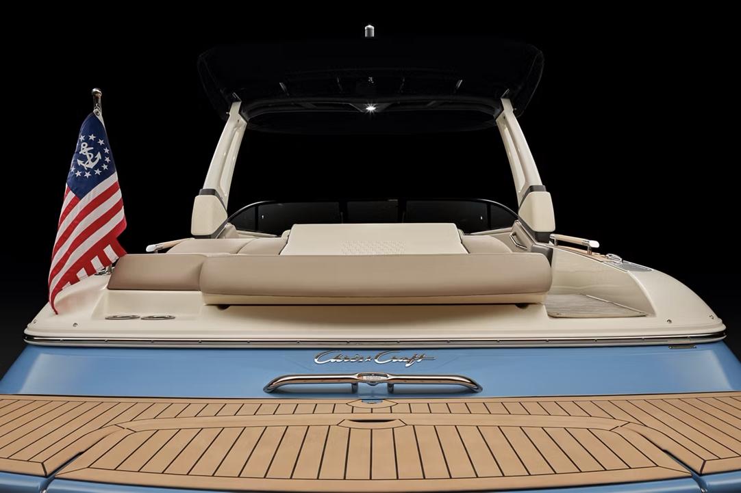 Manufacturer Provided Image: 2025 Chris-Craft Sportster 25 boat, rear view with American flag, teak deck.