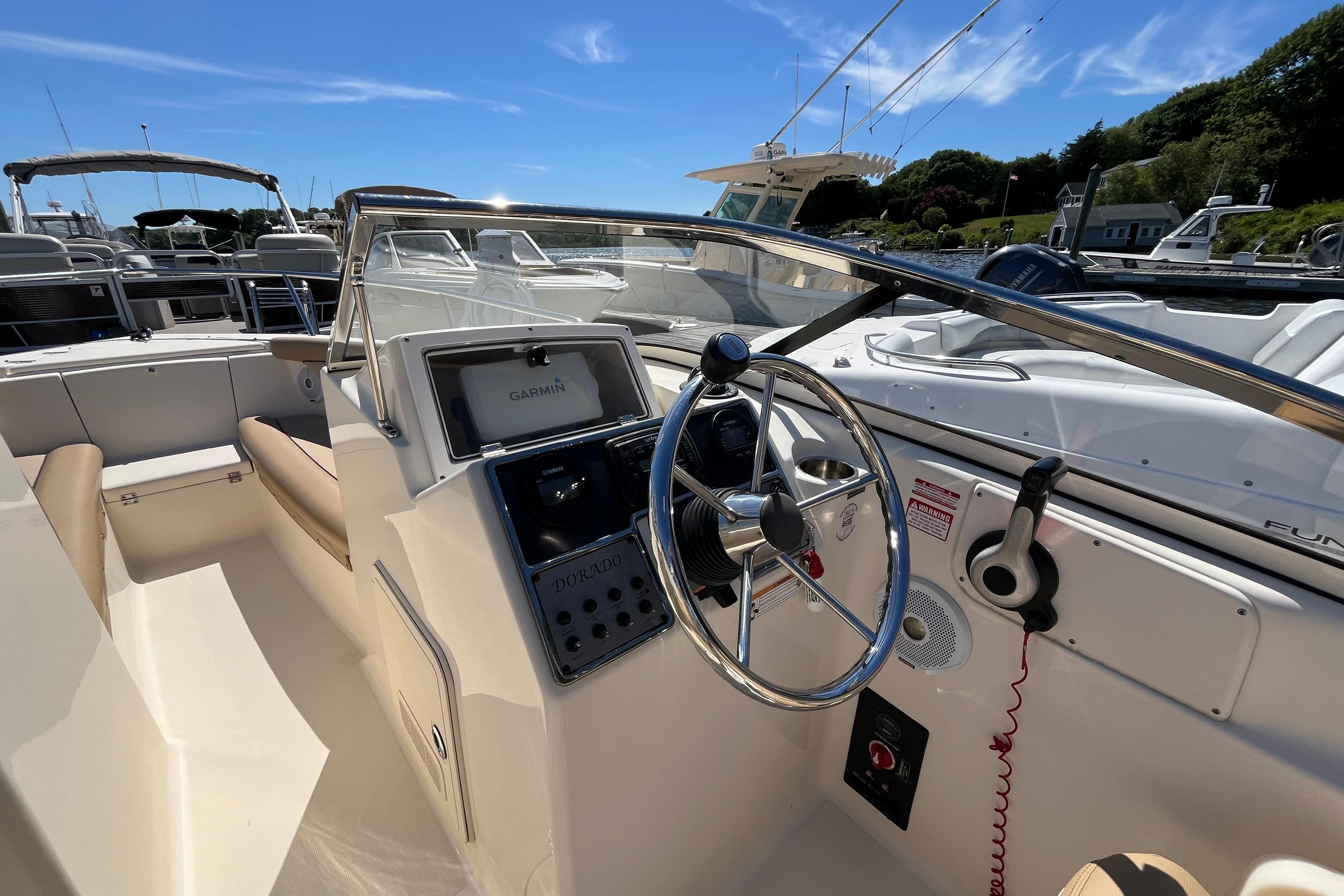 2017 Scout 210 Dorado boat interior with steering wheel and Garmin navigation system.