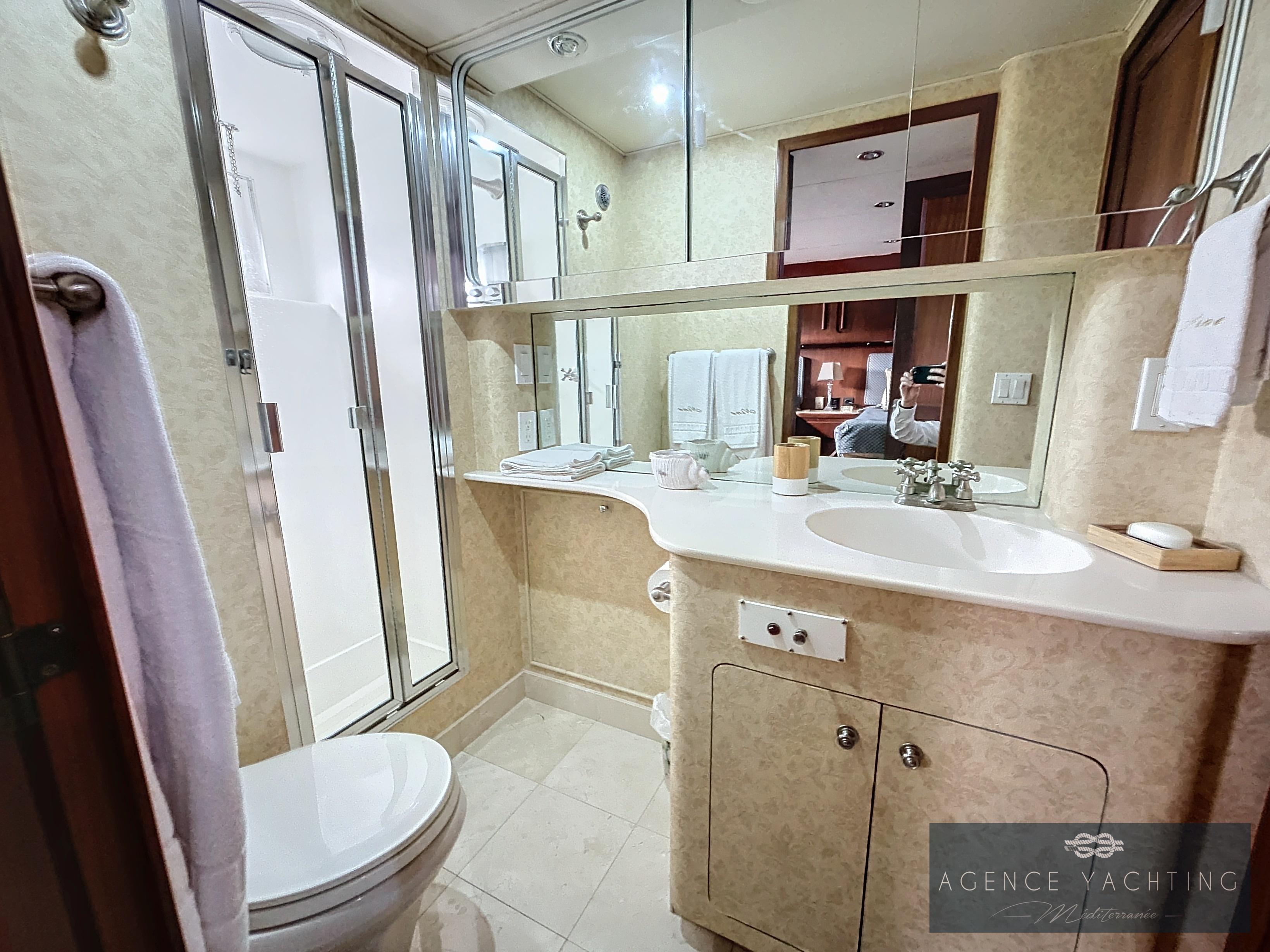 Luxurious bathroom in a 1987 Hatteras 85 yacht with modern fixtures and elegant design.