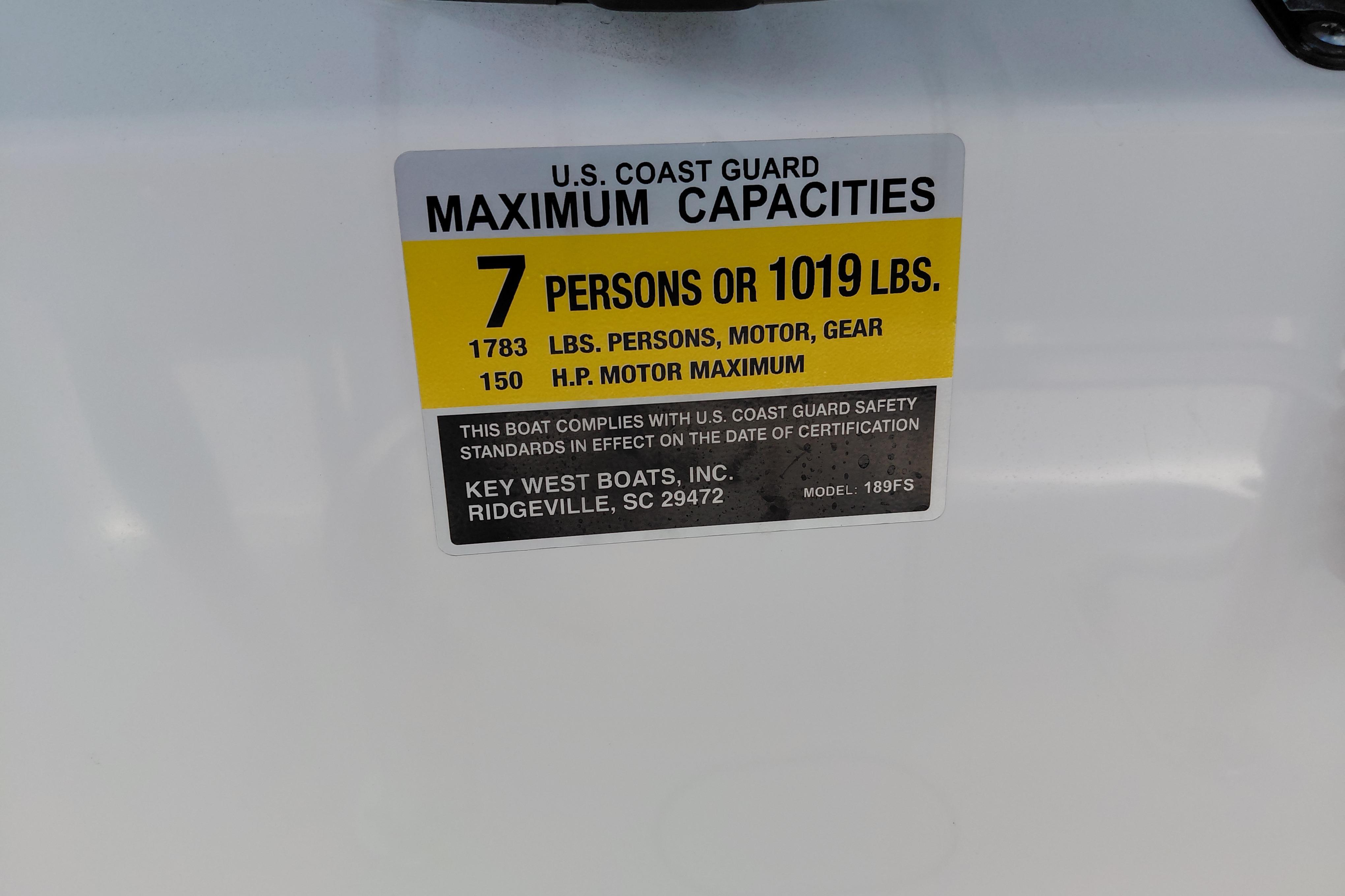 2023 Key West 189 FS boat capacity label, 7 persons or 1019 lbs, U.S. Coast Guard compliant.