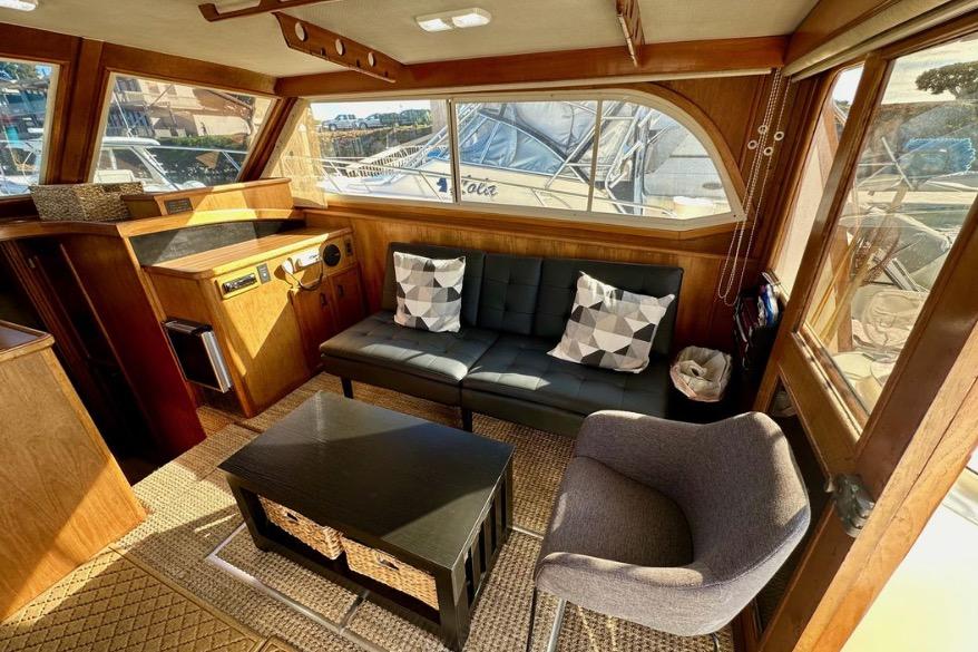 Interior of 1985 Egg Harbor 33 Sedan with modern seating and wooden accents.