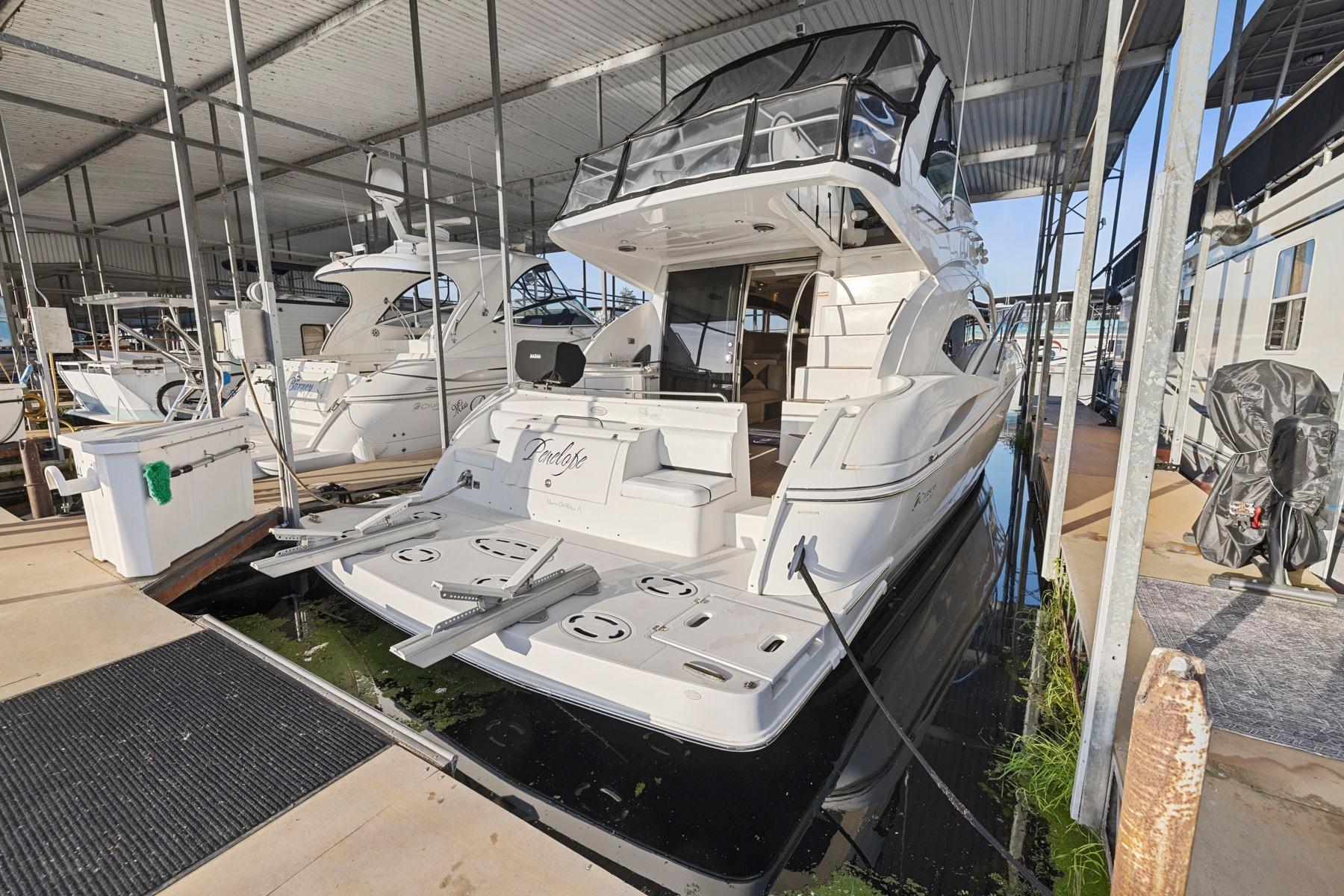 2008 Cruisers Yachts 447 Sport Sedan docked in a marina, rear view.