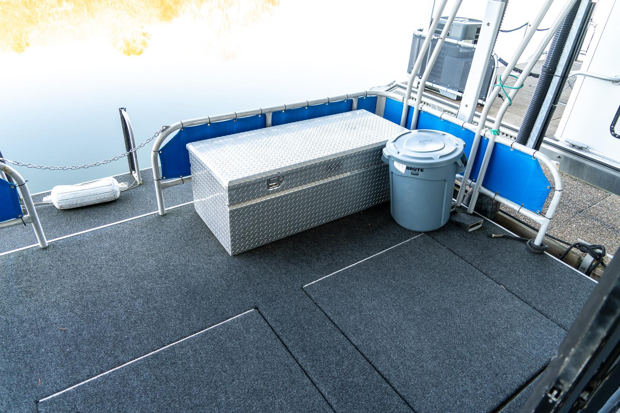 1996 Lakeview 66 x 16 Widebody Houseboat deck with storage box and trash bin.