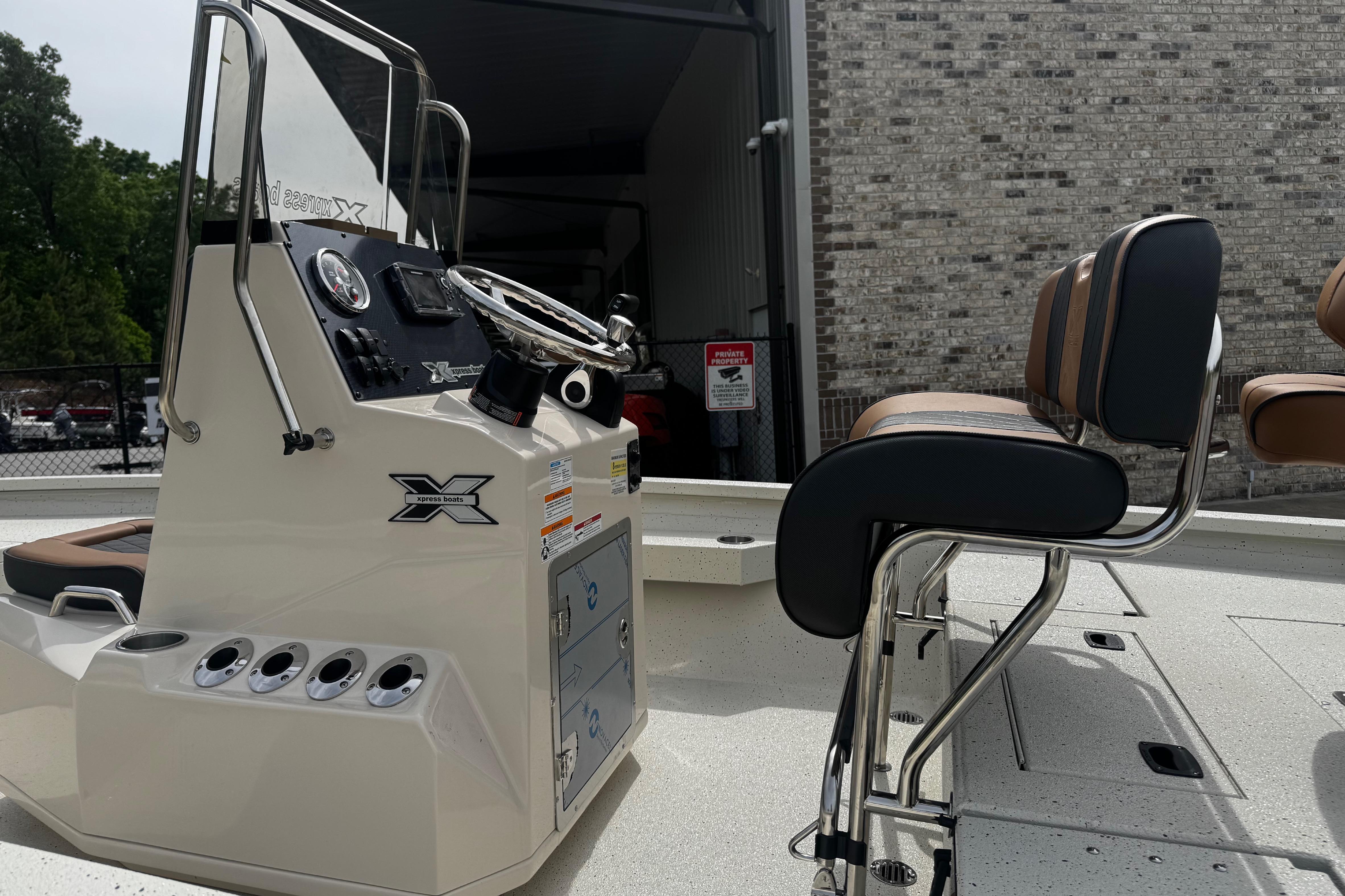 2026 Xpress H20B Bay boat interior with steering console and seating.