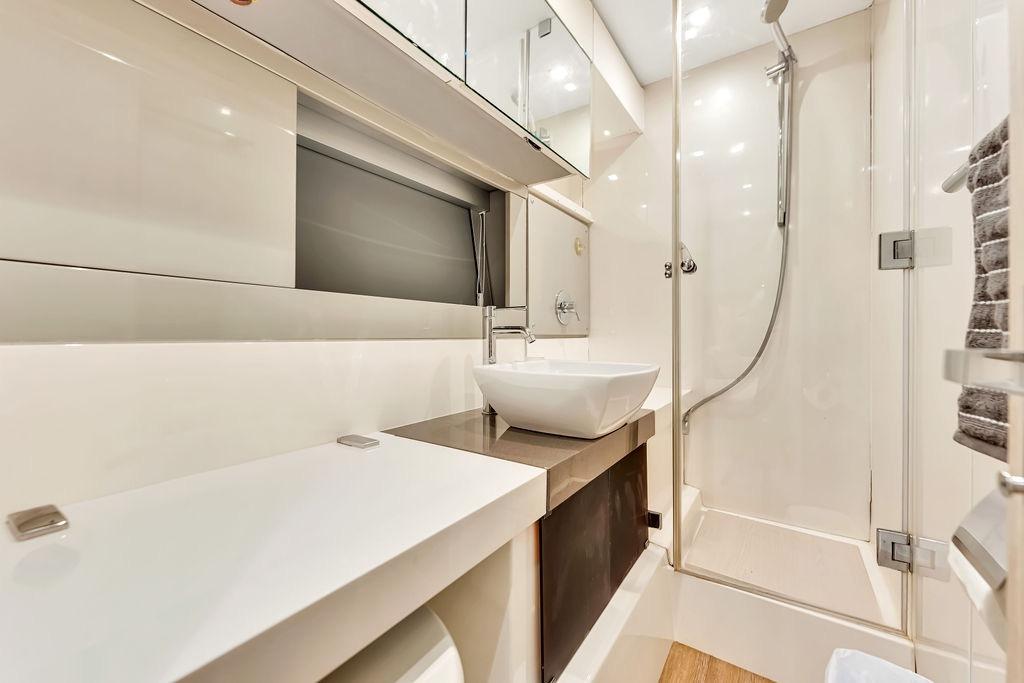 Luxurious bathroom in 2012 Fairline Targa 58 yacht with modern fixtures and shower.