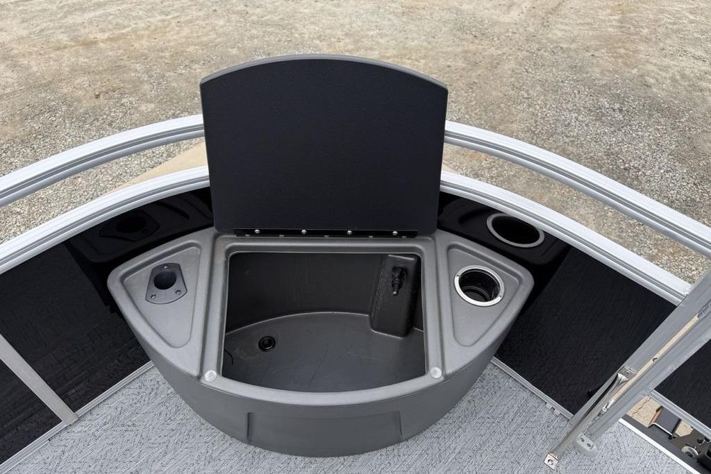 2026 Sun Tracker Fishin' Barge 20 DLX boat storage compartment with cup holders.