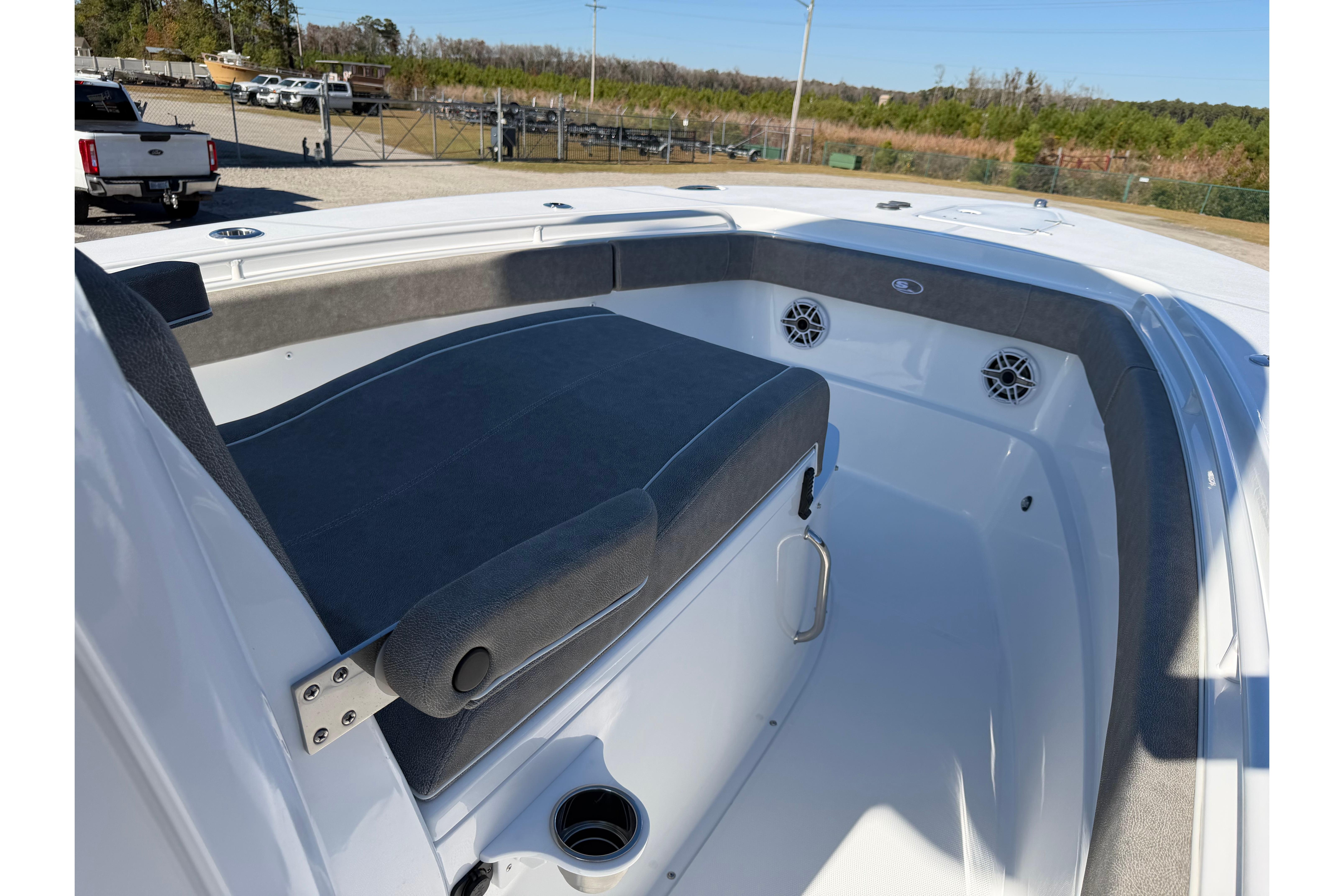 2026 Sea Hunt Ultra 275 Coffin Box boat interior with cushioned seating and speakers.