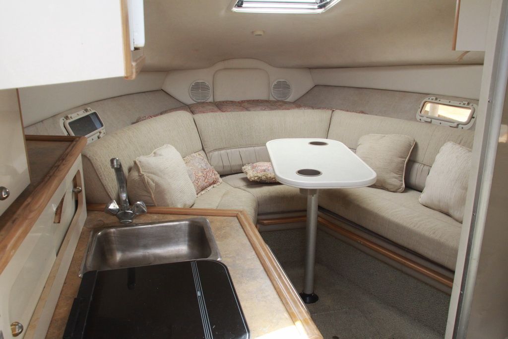 Interior of 1999 Maxum 2400 Mercruiser with seating area and table.