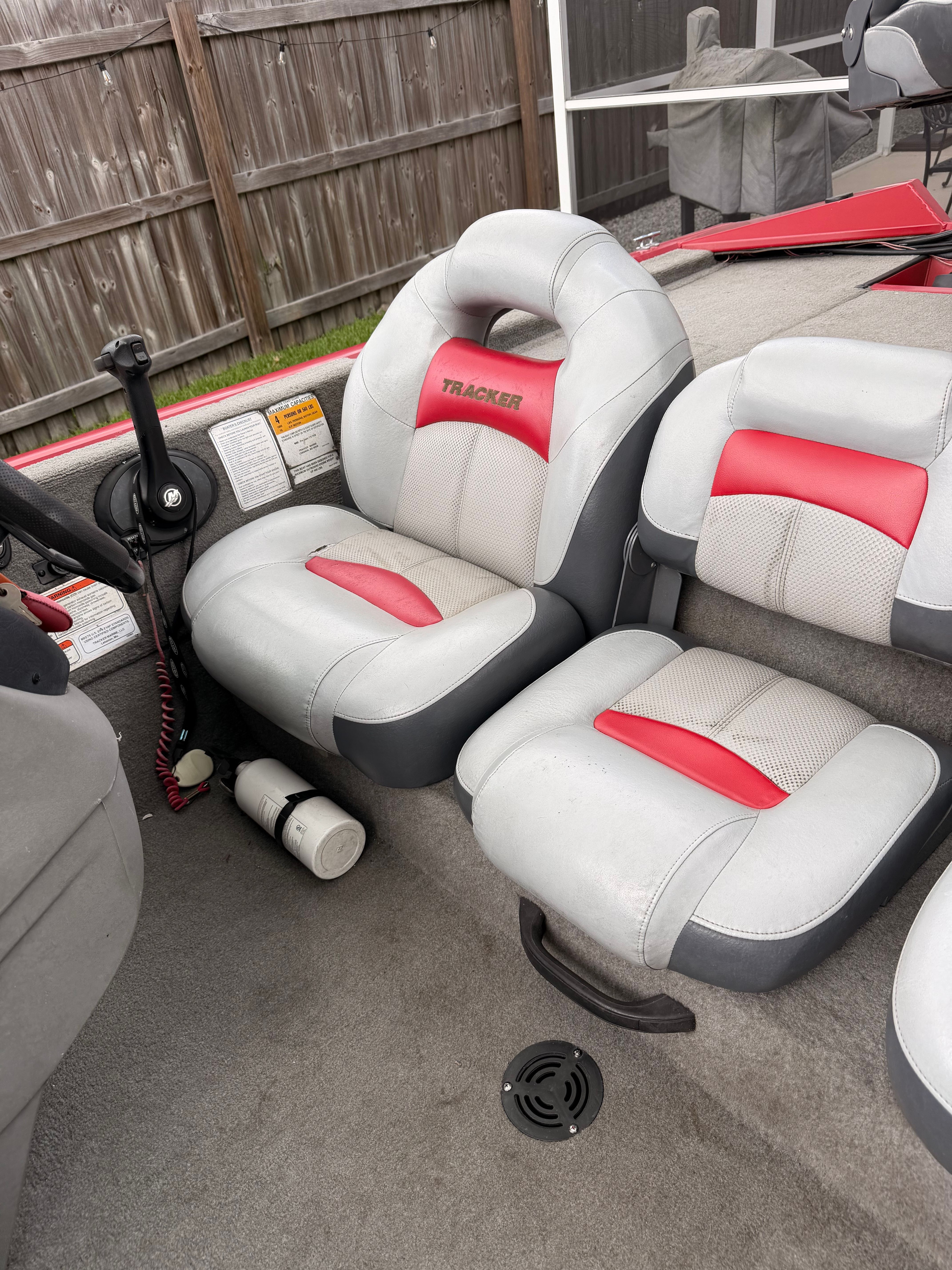Interior of a 2011 Bass Tracker PRO TEAM 175 TXW with gray and red seats.
