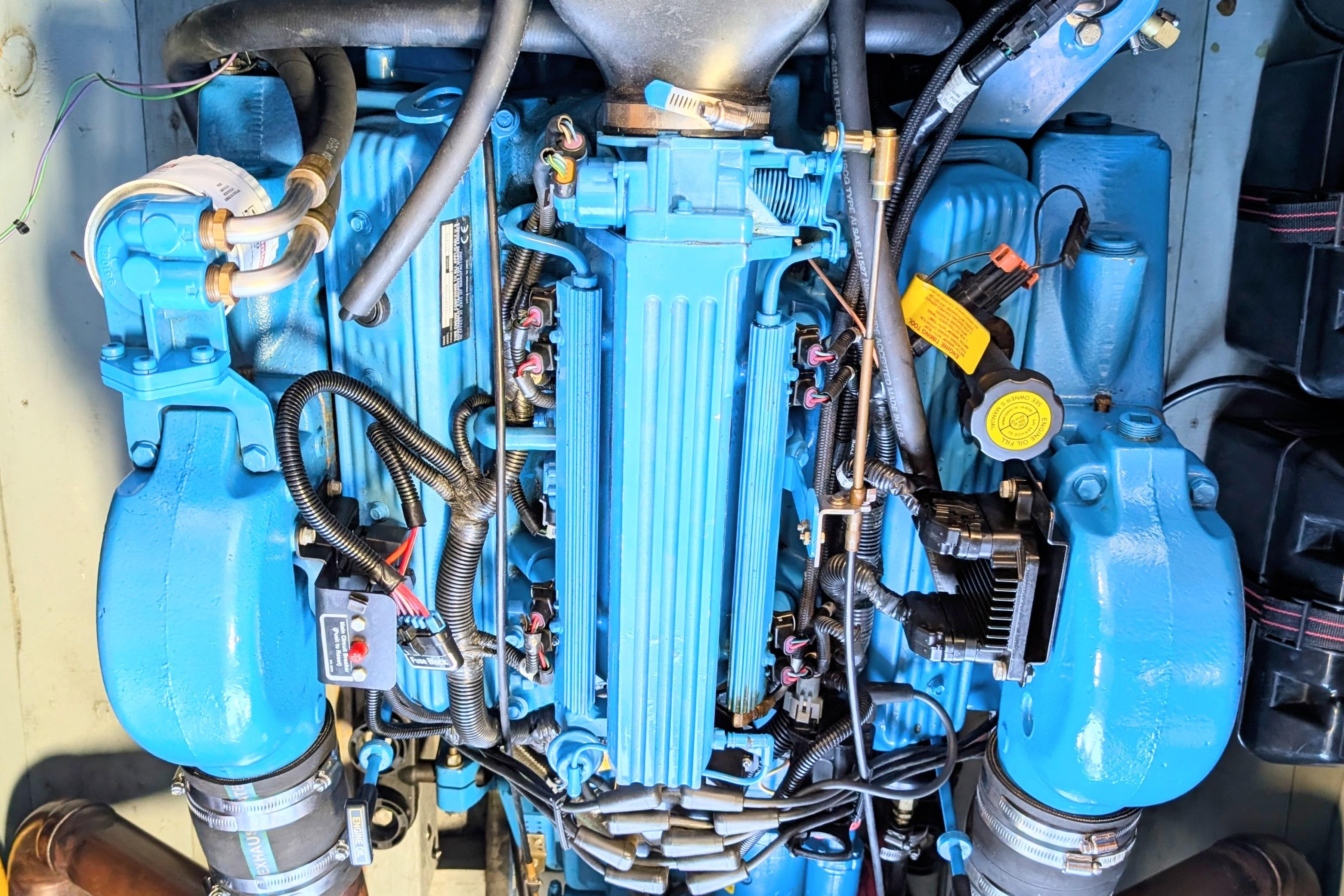 Engine of a 2001 Hacker-Craft 24 Dual Console, showcasing intricate blue components.
