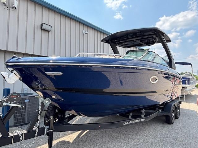 2026 Chaparral SSX 6 boat on trailer, sleek blue design, parked outdoors.