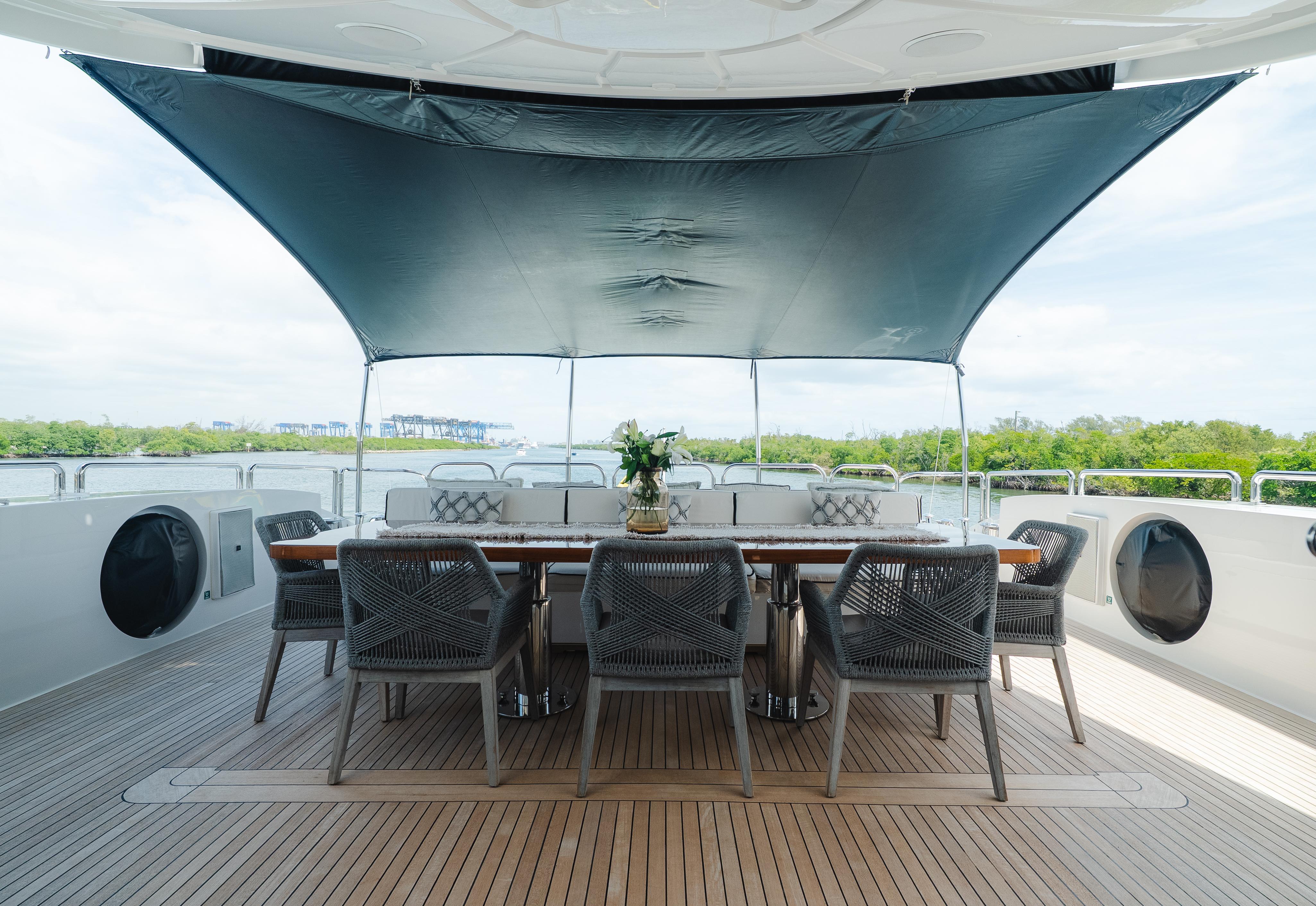 Outdoor dining area on 2010 Arno Leopard 46 yacht with canopy and elegant seating.