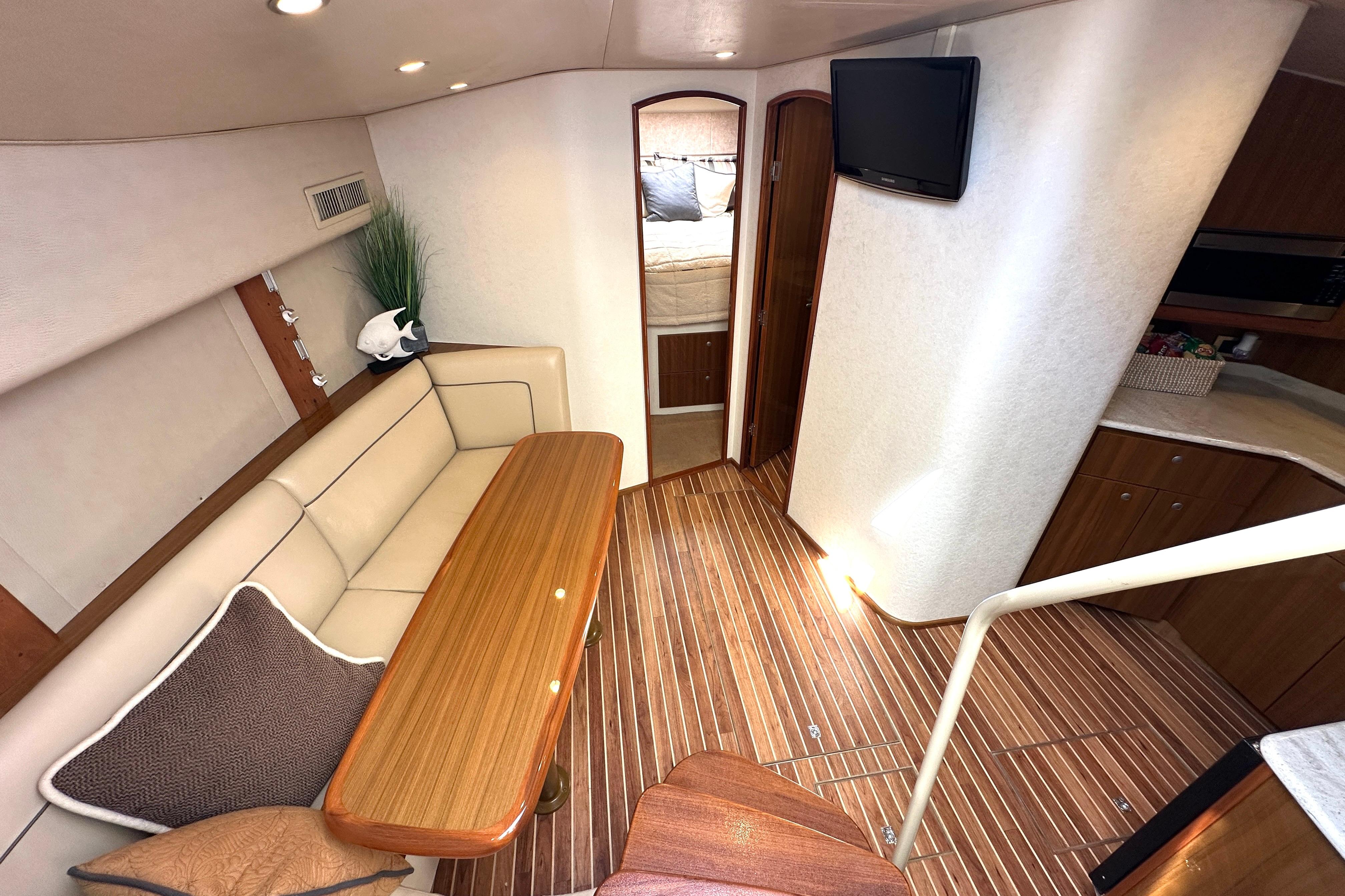 Interior of 2012 Viking 42 Open yacht with cozy seating and wooden flooring.