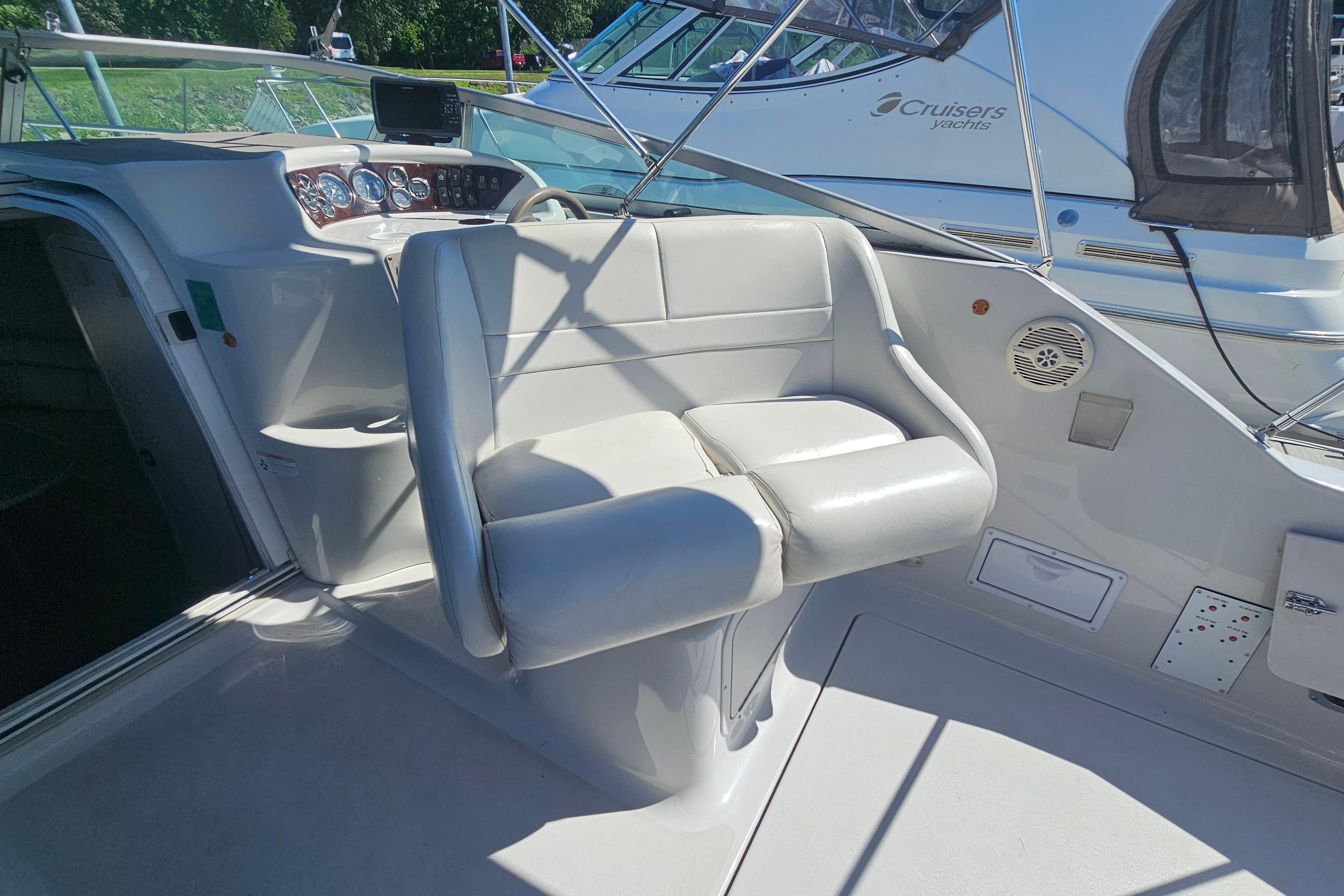 2000 Crownline 242 CR boat interior with white seating and control panel.