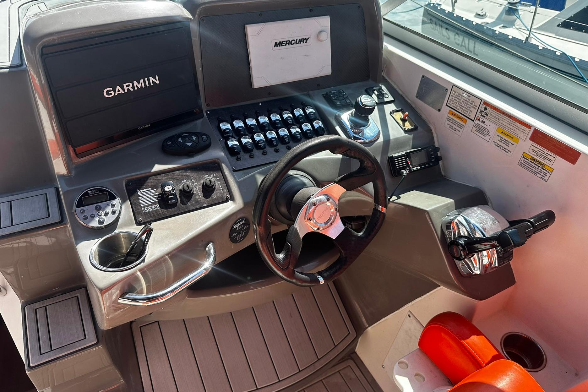 2012 Rinker 310 Express Cruiser LE helm with Garmin and Mercury controls.