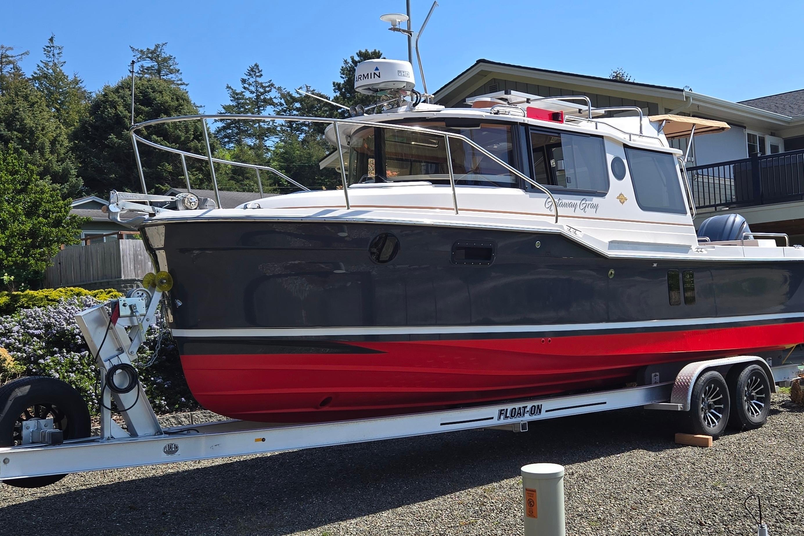 2023 Ranger Tugs R-25 boat on trailer outdoors.