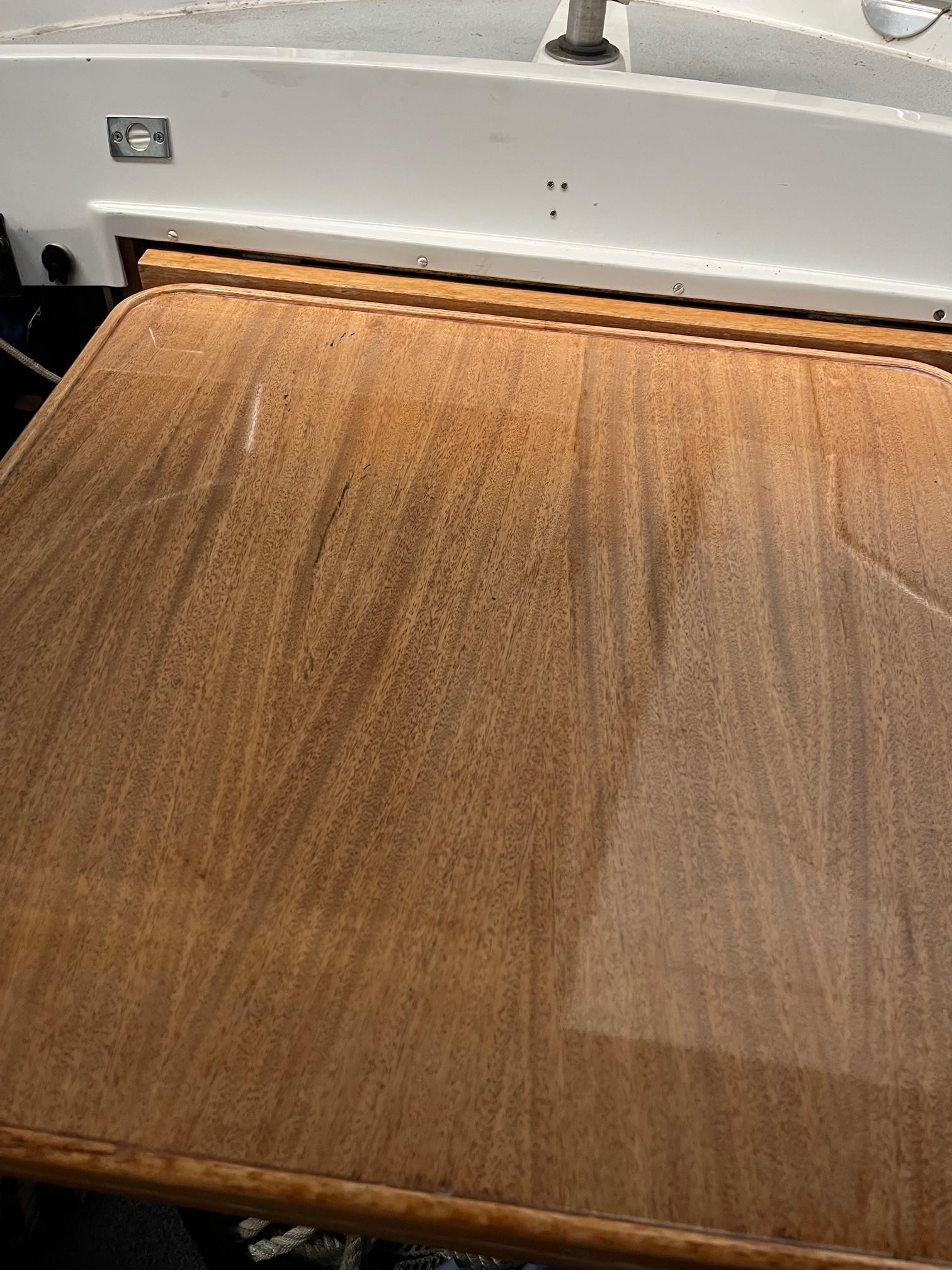 Wooden table surface on a 1980 LM 32 boat interior.