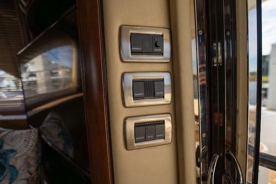 Control panel inside 2006 Sea Ray 580 Sedan Bridge yacht, featuring modern switches.