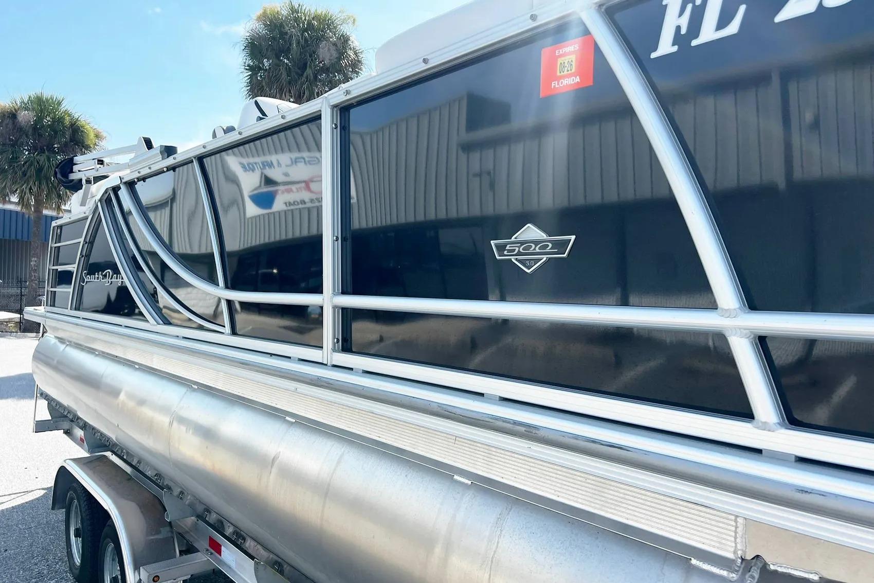 2023 South Bay 523 R pontoon boat on trailer, Florida registration visible.