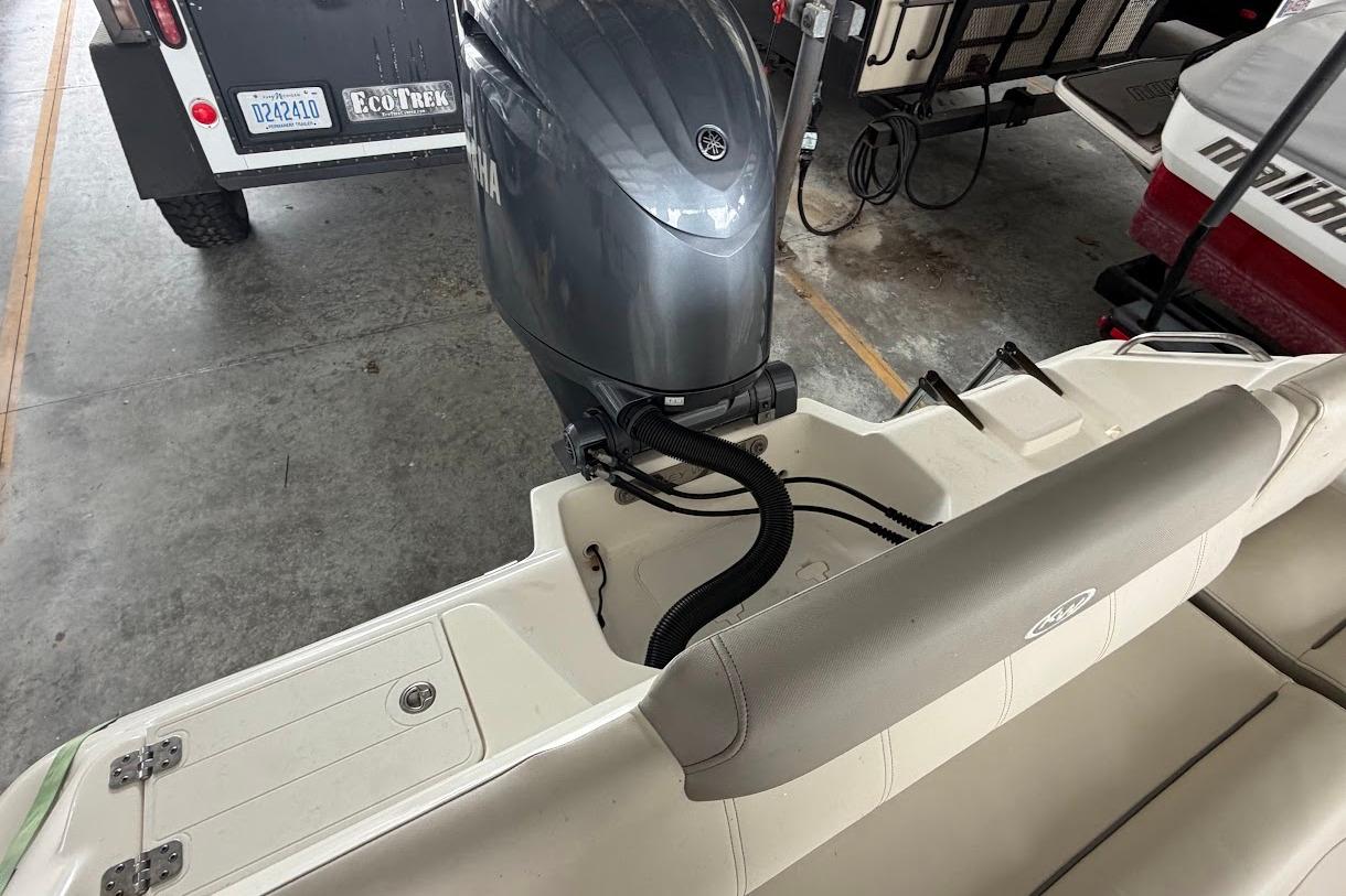 2024 Key West 219 FS boat with Yamaha outboard motor in storage.