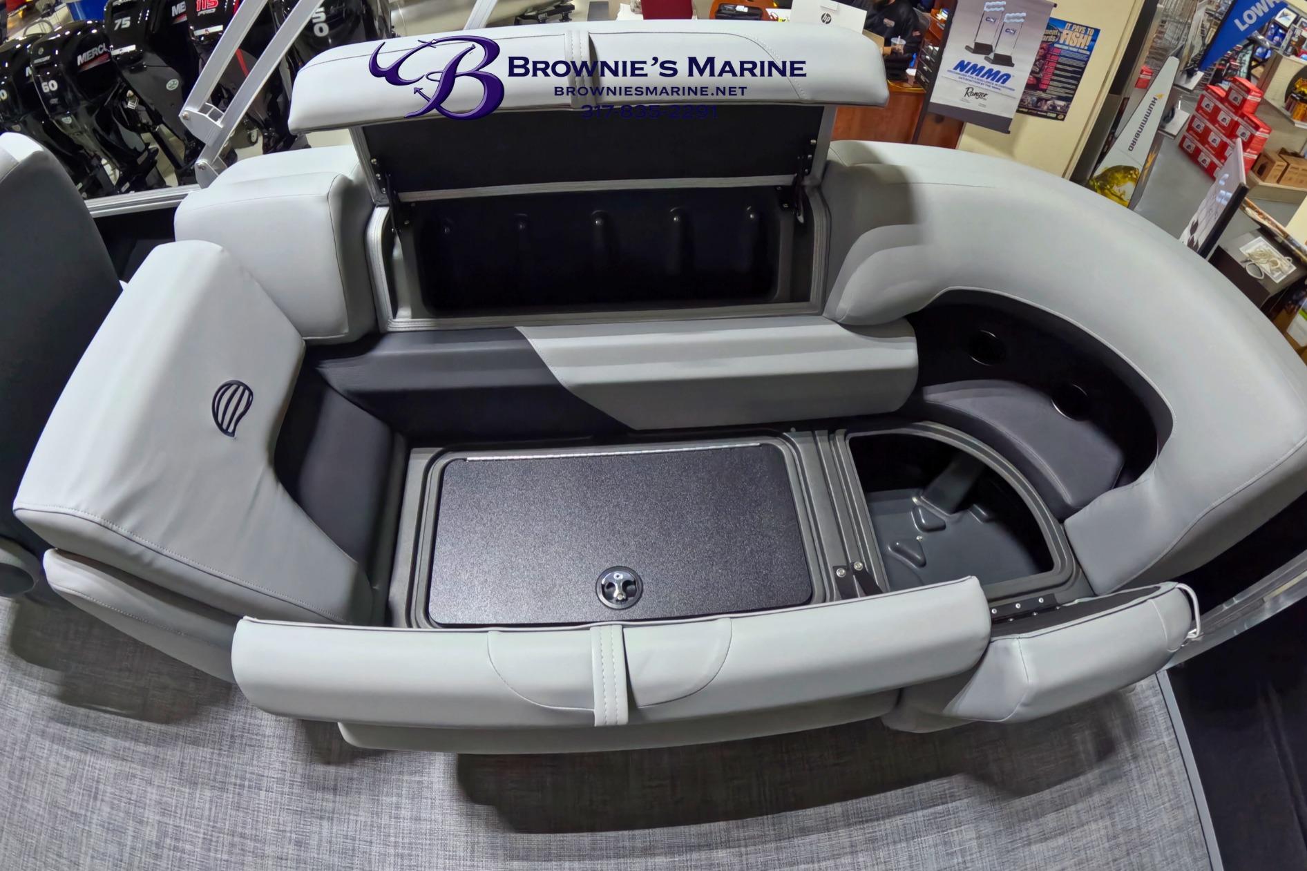 2026 Sun Tracker Party Barge 24 XP3 interior seating with storage compartments at Brownie's Marine.