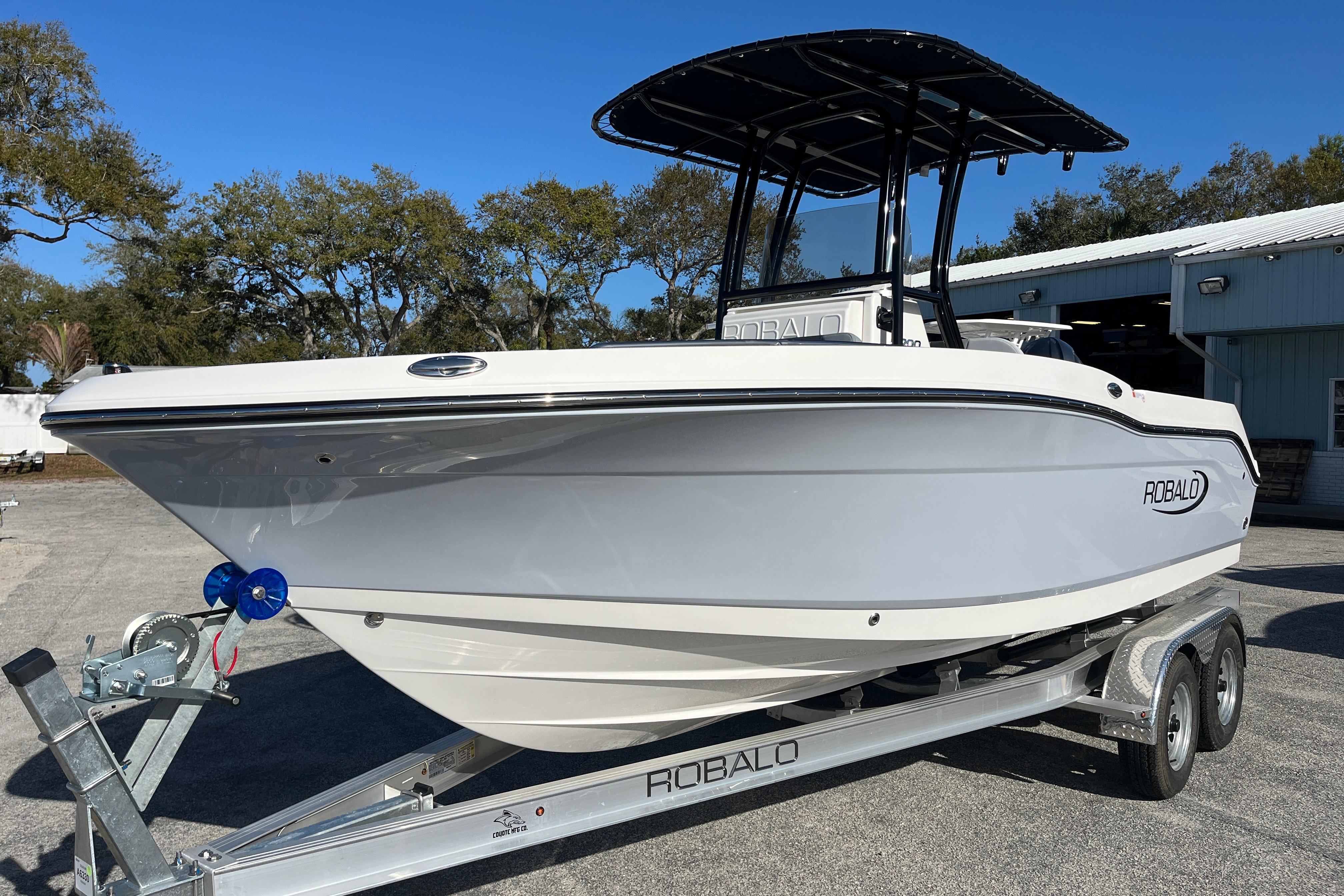 2026 Robalo R200 Center Console boat on trailer, parked outdoors.