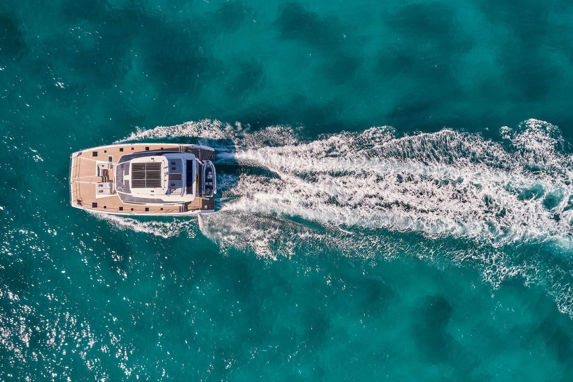 Aerial view of 2023 Fountaine Pajot Power 67 cruising in turquoise waters.