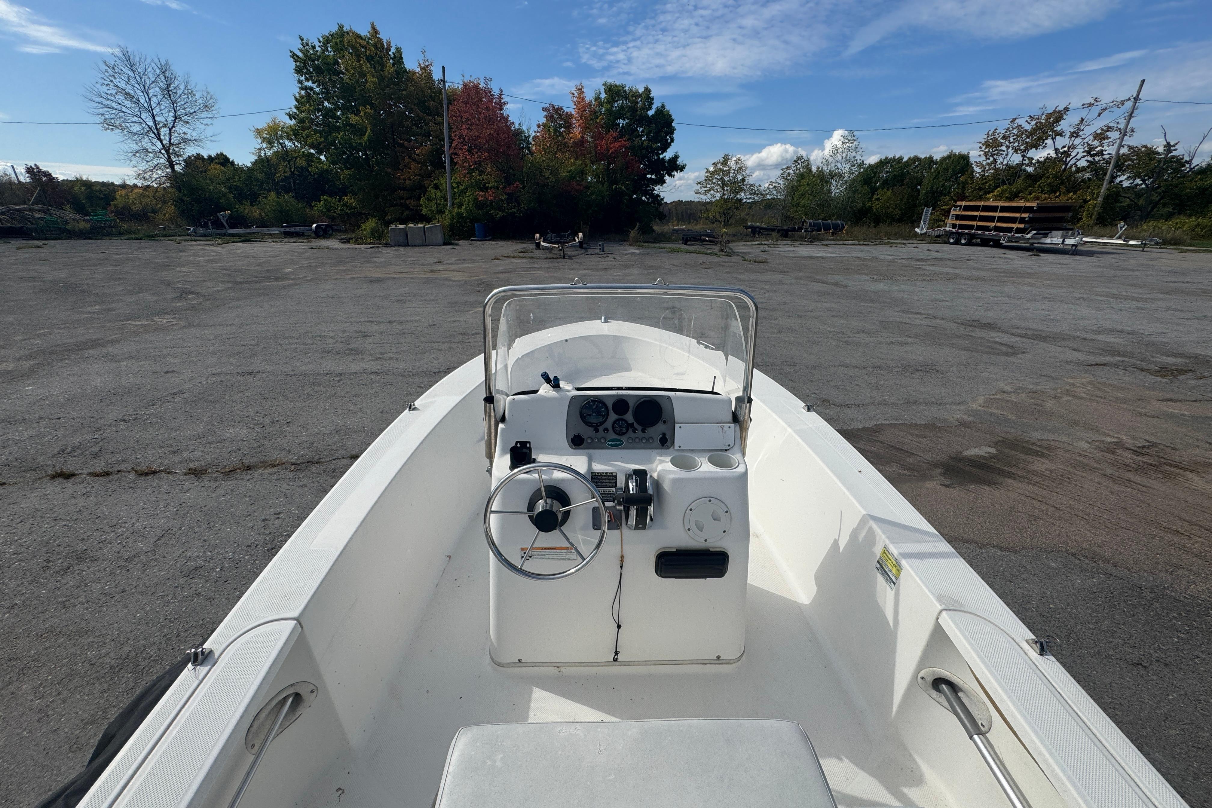2007 Trophy 1703 Center Console boat in a parking lot, clear sky background.