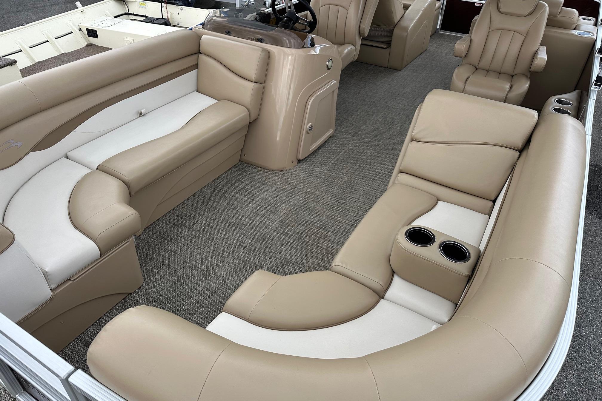 Luxurious interior of a 2016 Bennington 24 SCWX pontoon boat with beige seating.