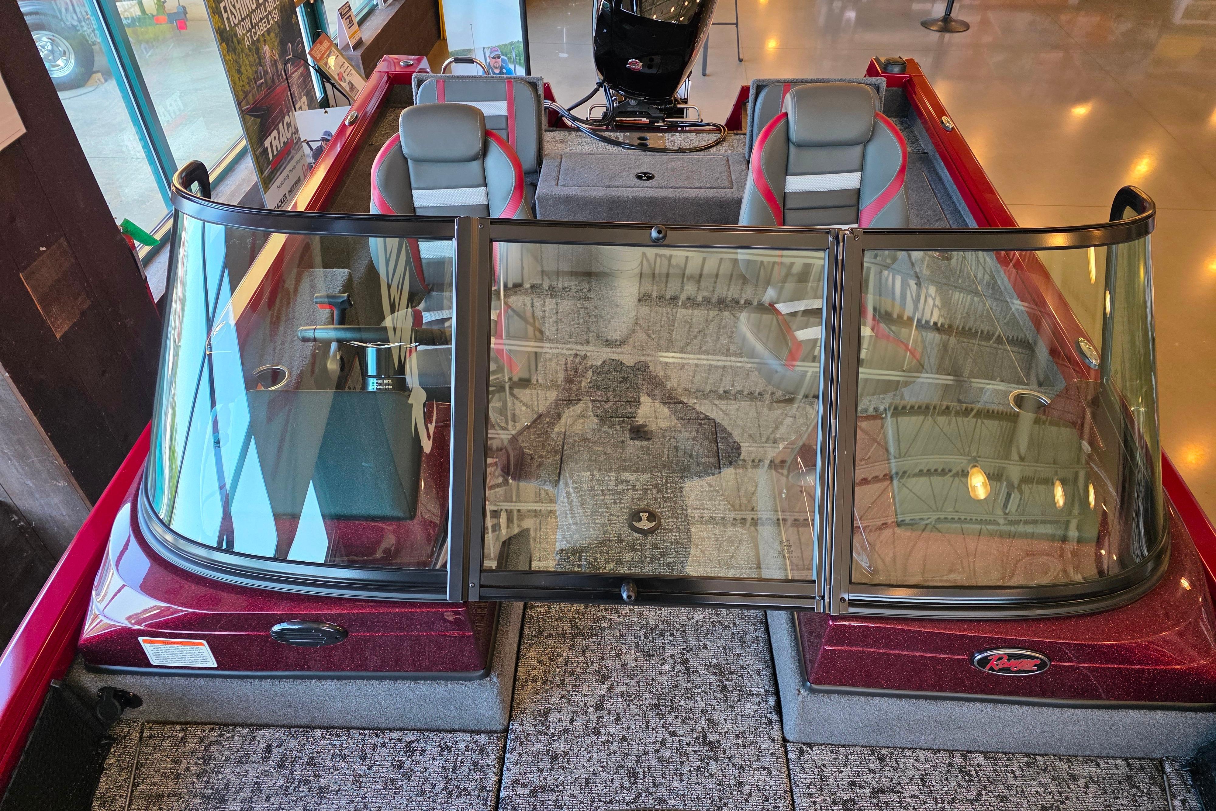 2026 Ranger VS1782SC Reata boat interior with dual seats and windshield in showroom.