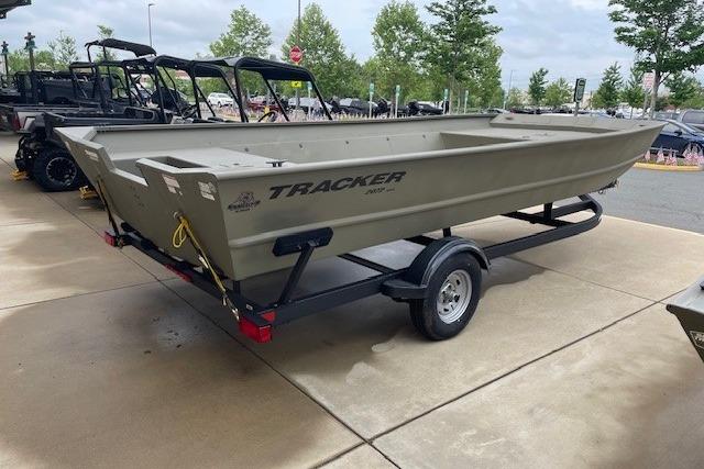 2025 Tracker Grizzly 2072 Utility boat on trailer, parked outdoors.