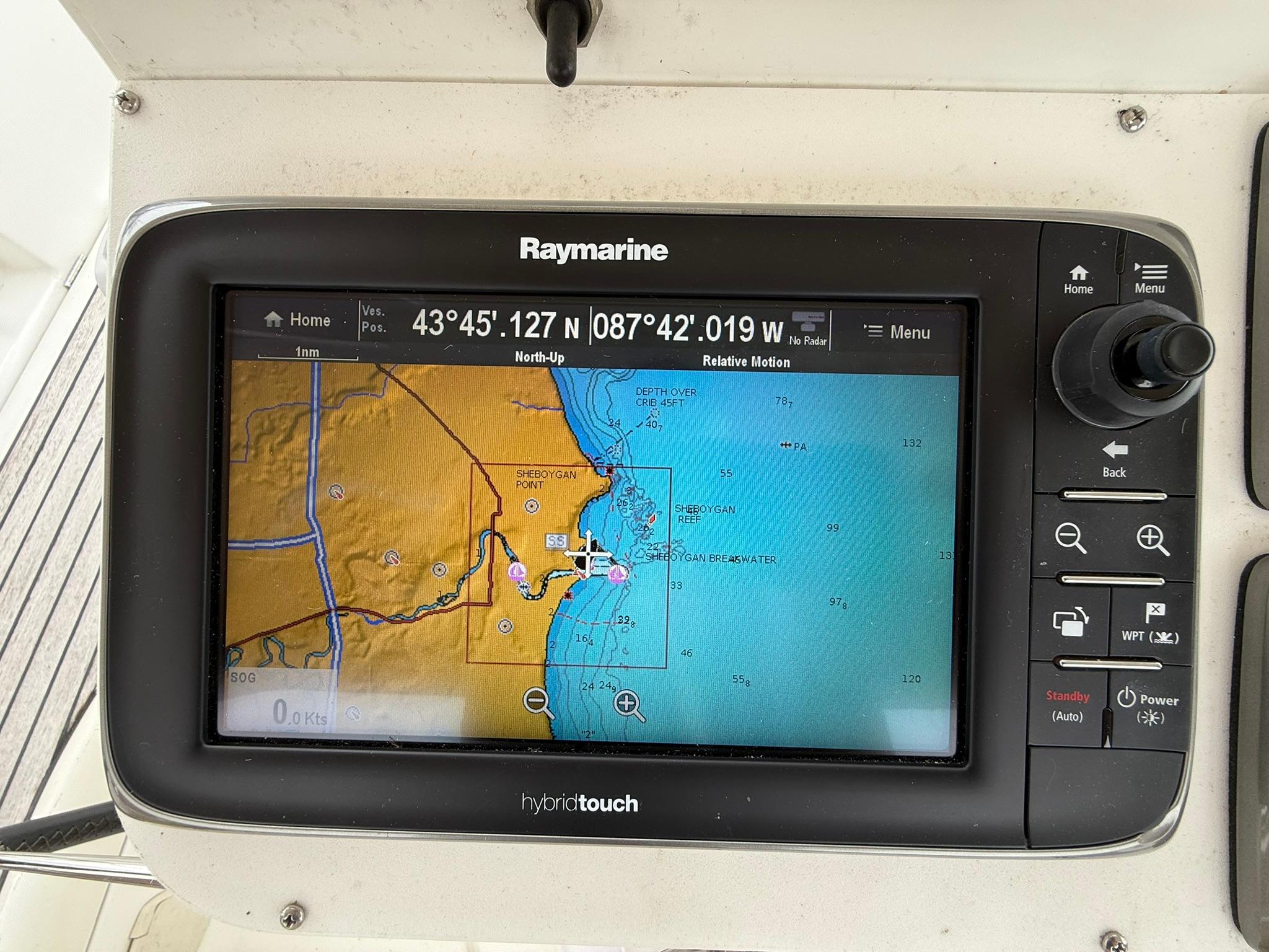 Raymarine navigation display on 2003 Beneteau 393, showing nautical chart and coordinates.
