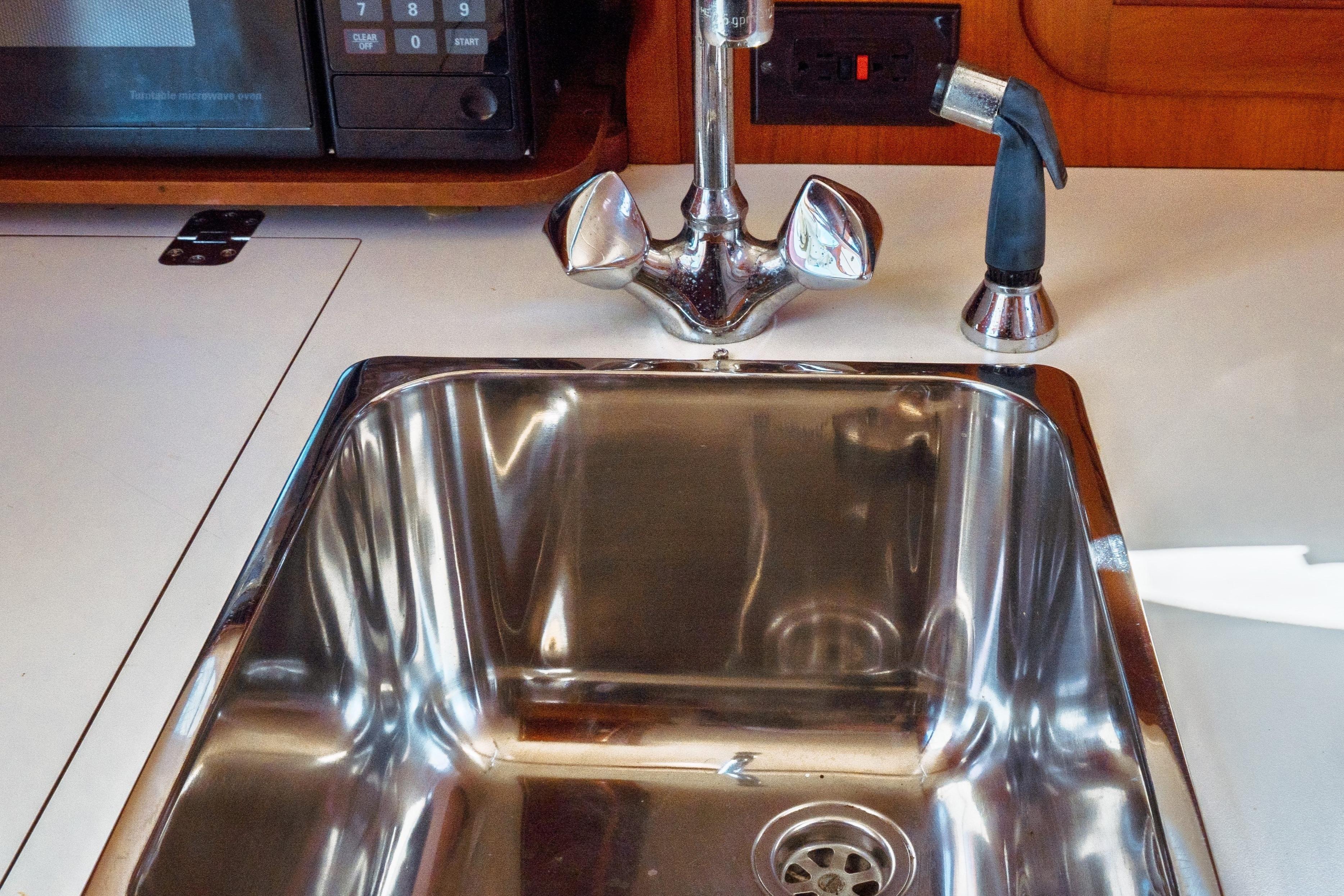 Stainless steel sink in 2000 Hinckley Picnic Boat Classic galley.