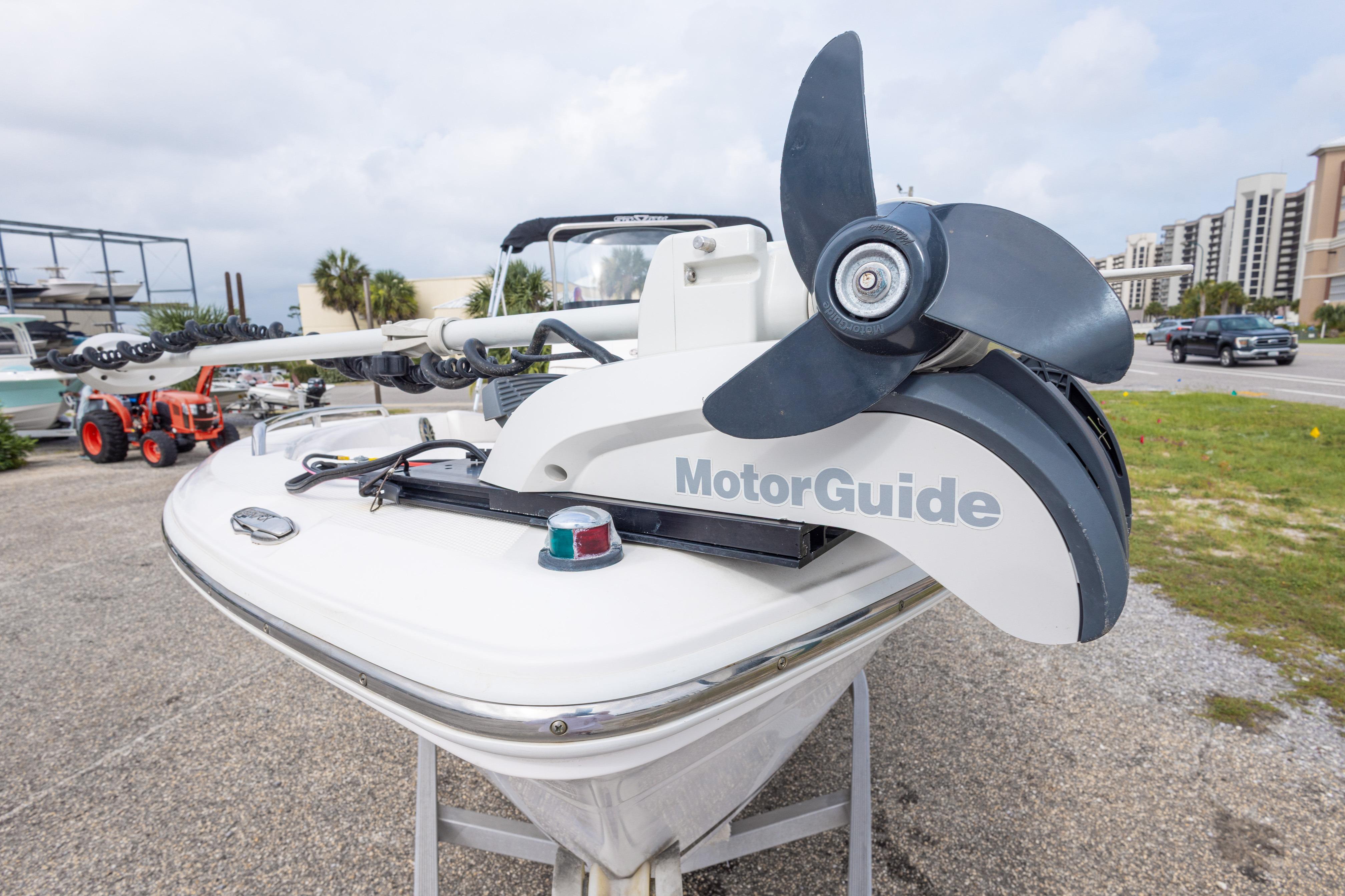 2014 Sea Fox 209 Commander boat with MotorGuide trolling motor, parked outdoors.