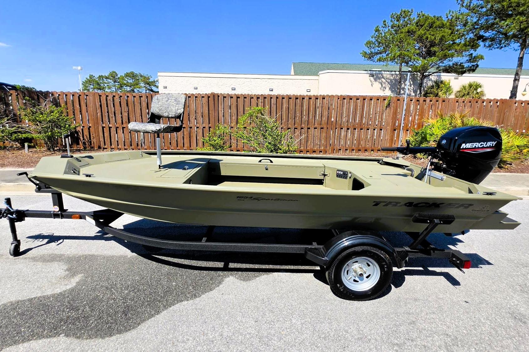 2026 Tracker Grizzly 1654 T Sportsman boat with Mercury engine on trailer.