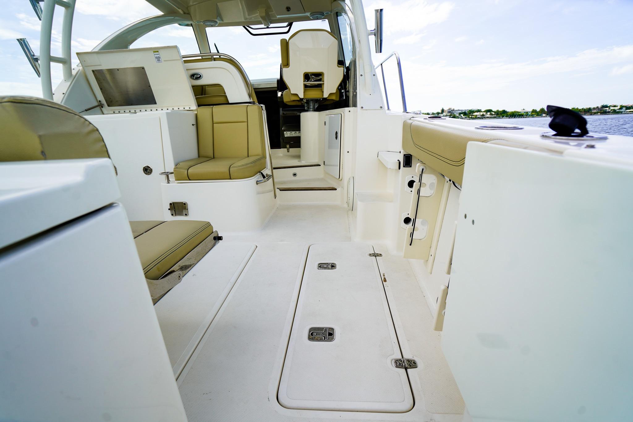2020 Pursuit OS 325 Offshore boat interior with beige seating and open deck layout.