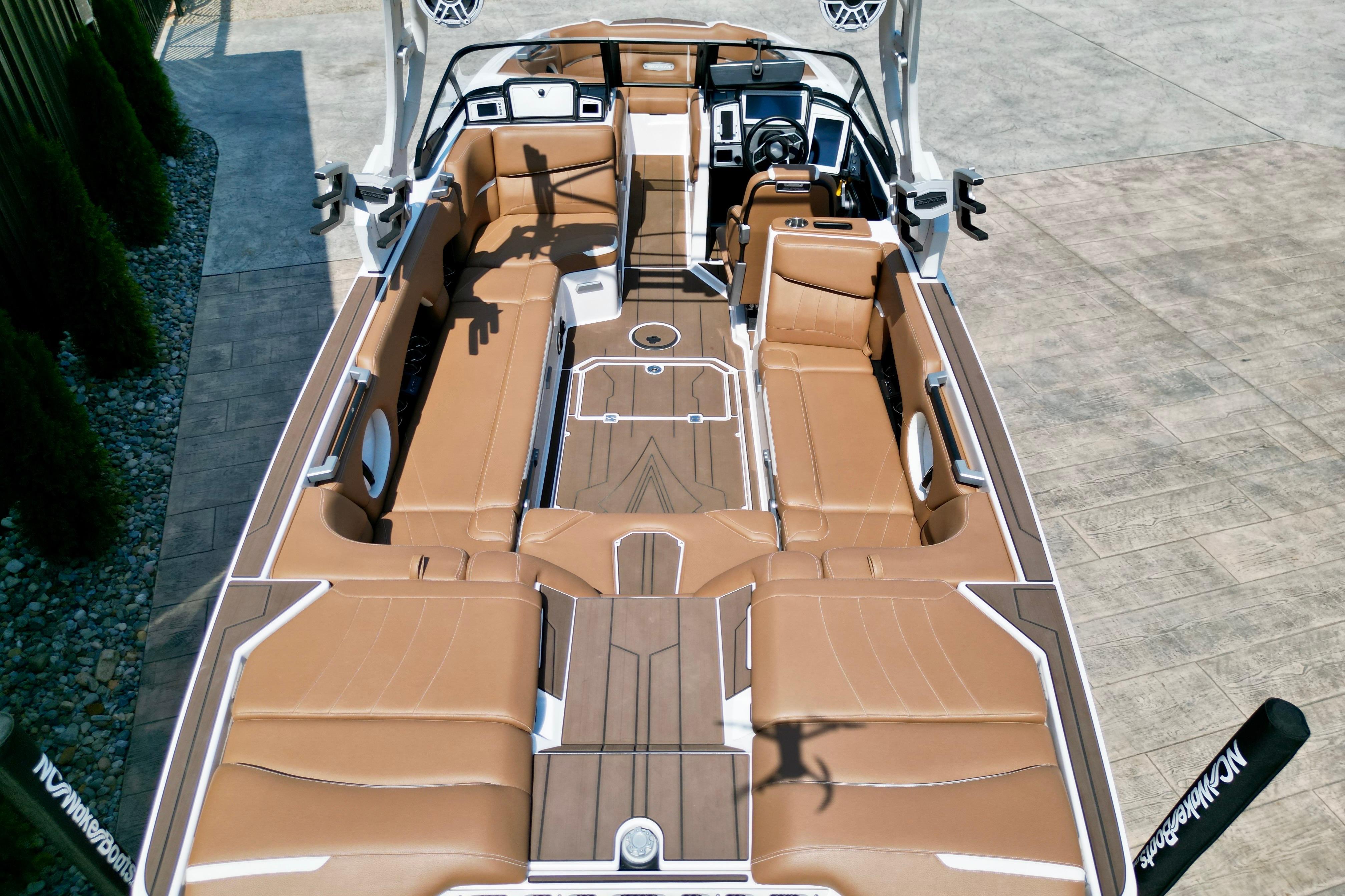 2021 Supra SE boat interior with tan leather seating and modern dashboard.