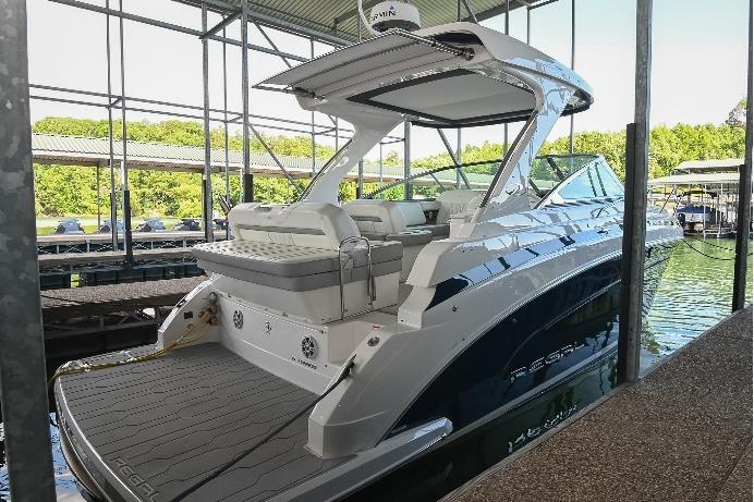 2021 Regal 33 Express boat docked in a marina, showcasing sleek design and modern features.