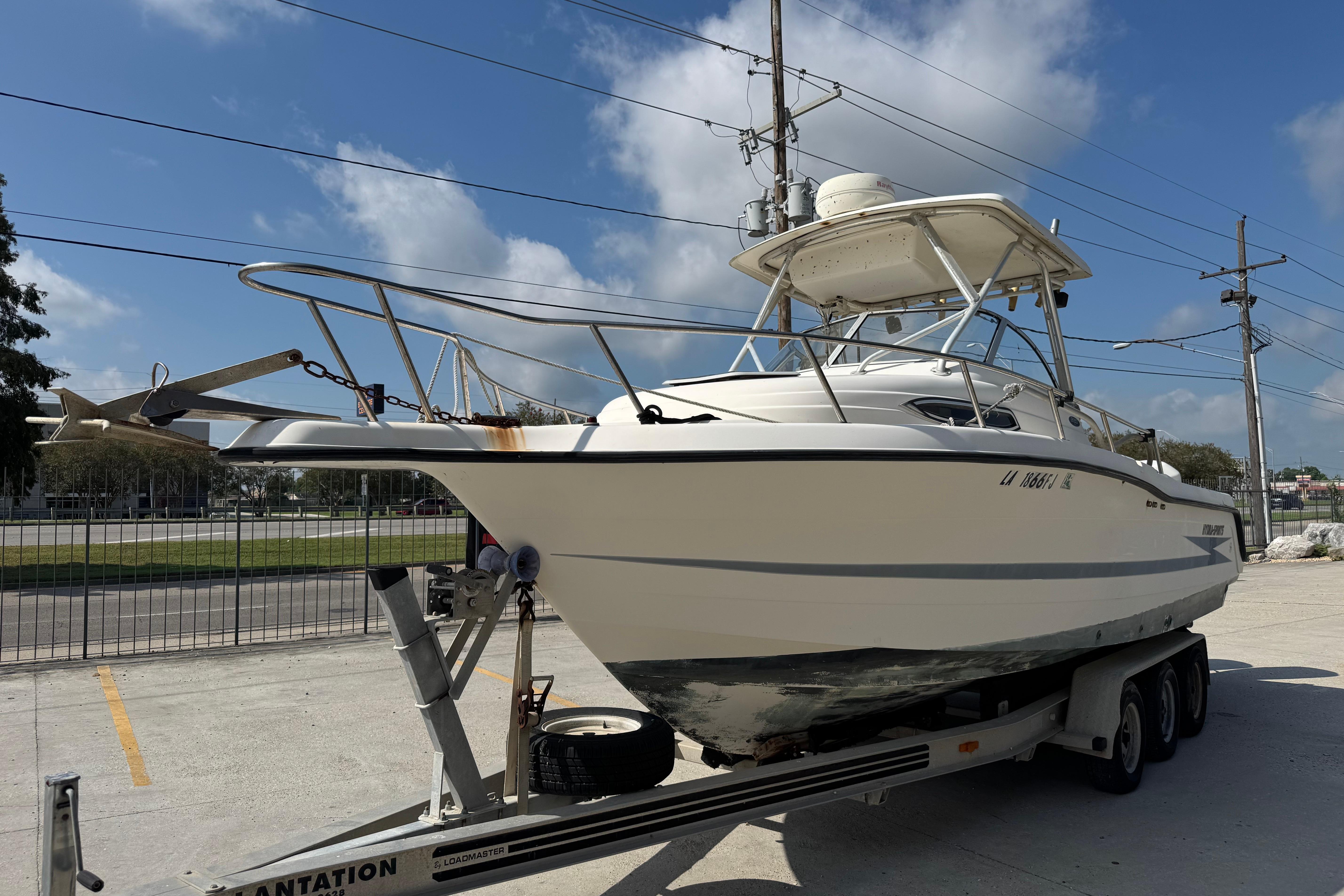 1997 Hydra-Sports VECTOR 2650 WA boat on trailer under blue sky.