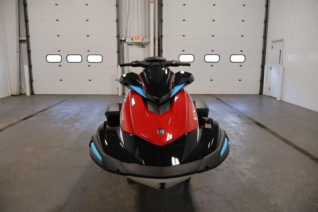2026 Yamaha WaveRunner VX Deluxe in a garage, front view, red and black design.