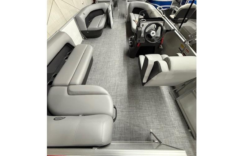 2026 Sun Tracker Party Barge 16 DLX interior with gray seating and steering console.