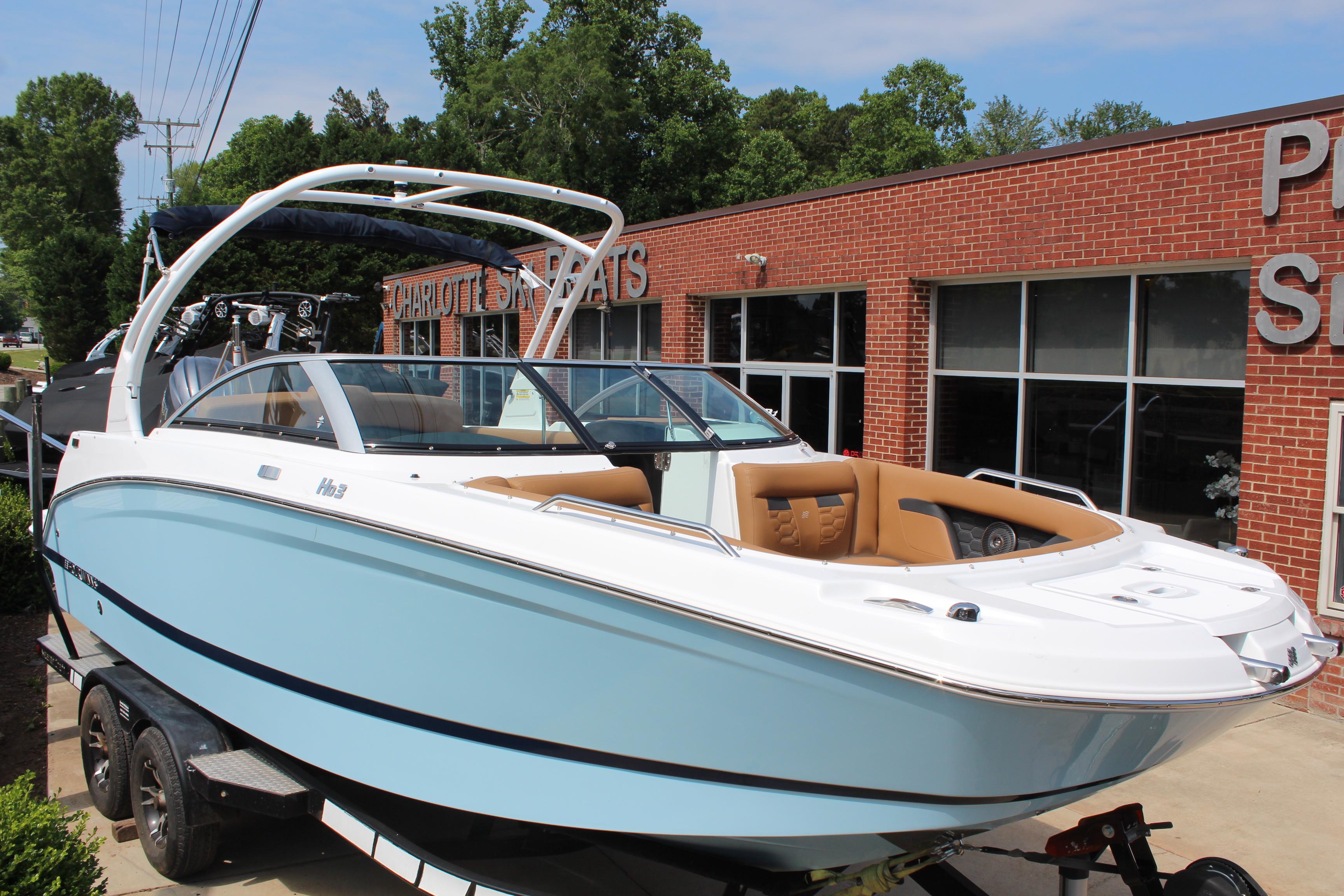 2025 Four Winns HD3 OB boat displayed outside a dealership, featuring sleek design and modern amenities.