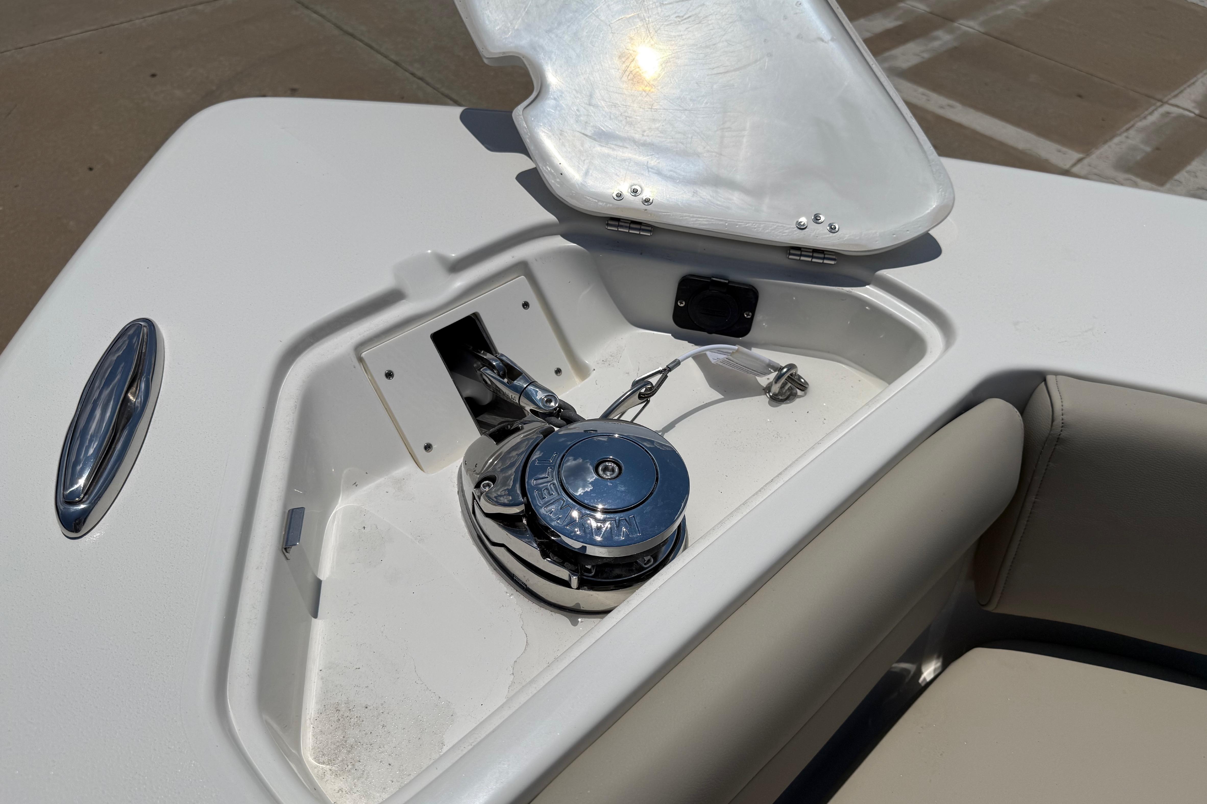 2027 Key West 249 FS boat anchor compartment with open hatch and winch.