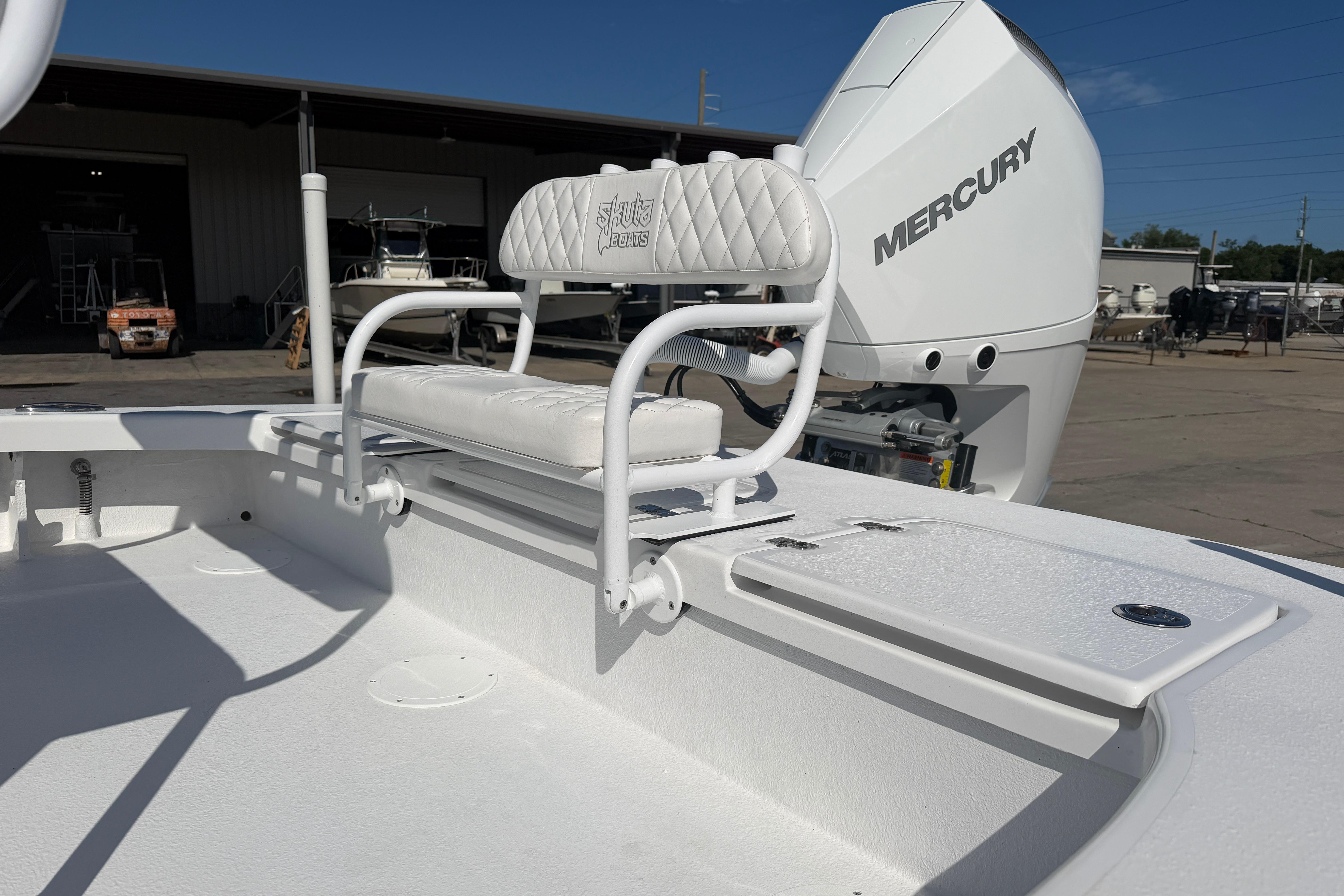 Skuta 24 Cat 2026 boat with Mercury engine, featuring white seating and deck.