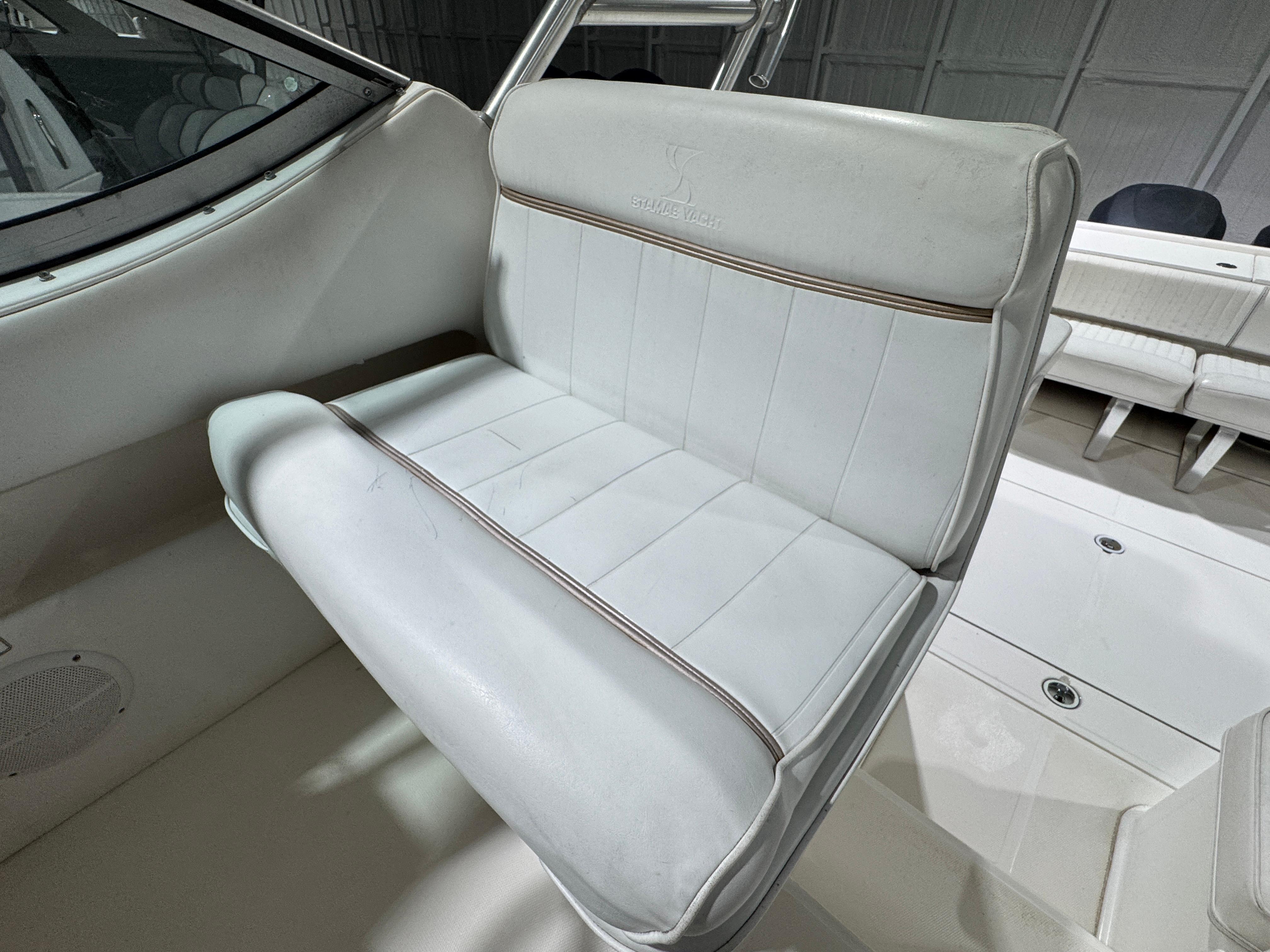 2005 Stamas 310 Express boat interior with white cushioned seating.