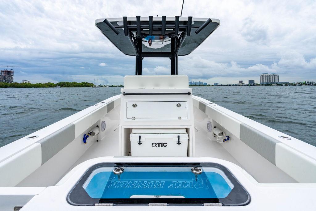 Modern 2027 Reef Runner 280 boat on water, featuring sleek design and spacious deck.