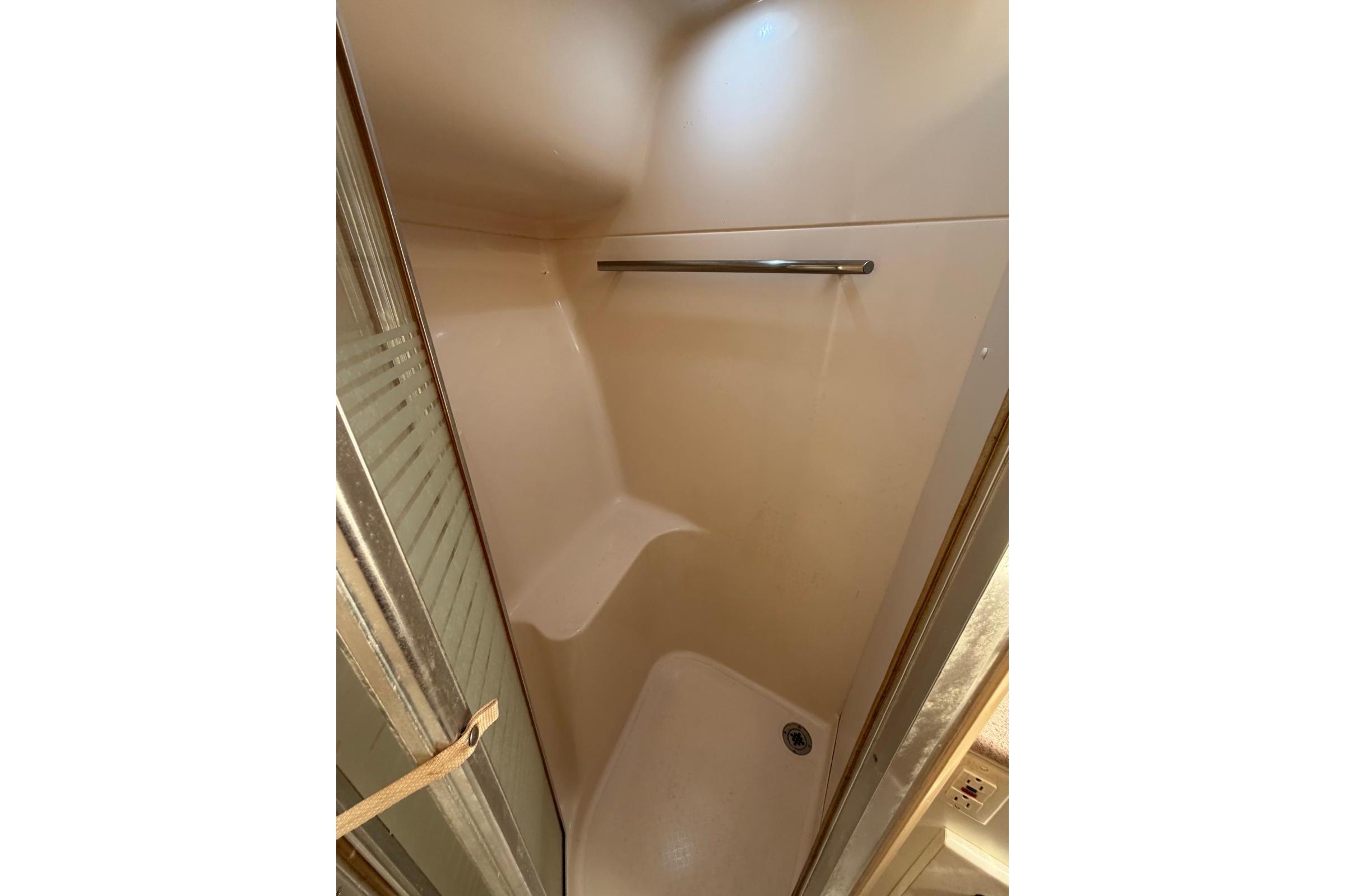 Shower area inside 1999 Tiara Yachts 4100 Open, featuring a sleek design and modern fixtures.