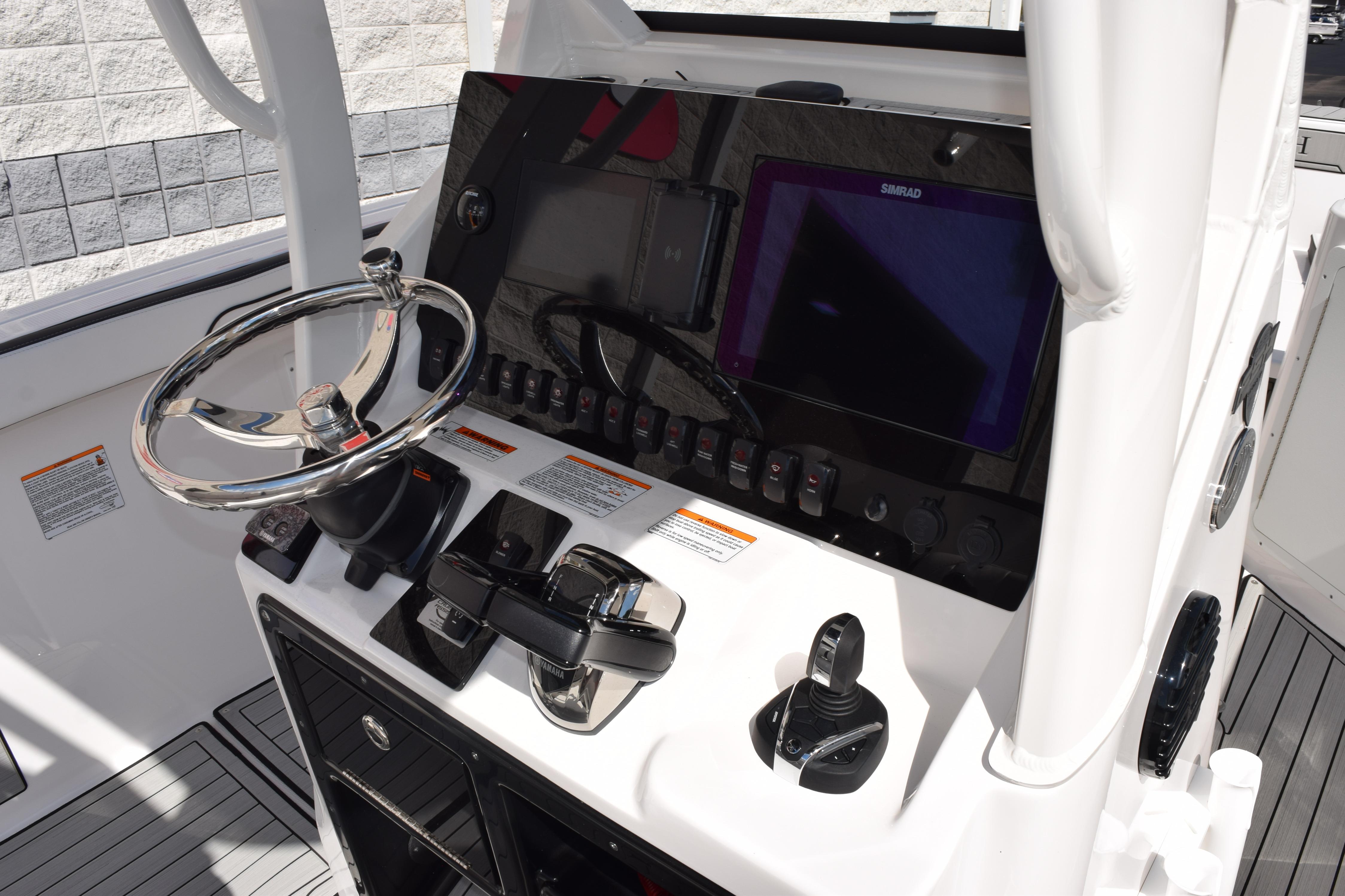 2026 Yamaha Boats 255 FSH Sport H dashboard with steering wheel and control panel.