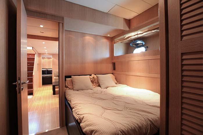 Luxurious cabin interior of 2005 Arno Leopard 24 yacht with cozy bedding.
